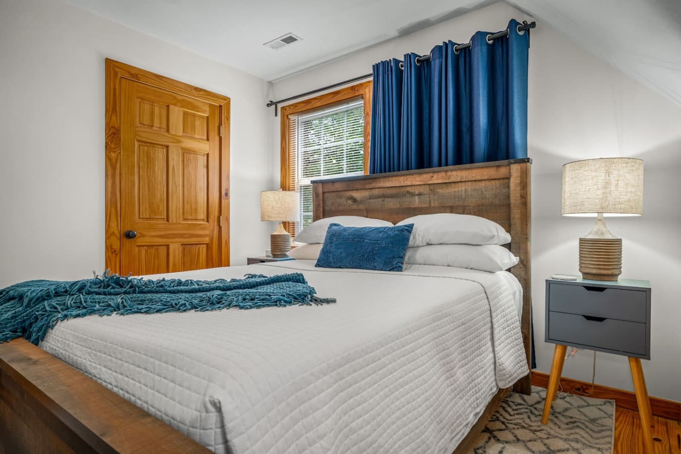 Upstairs bedroom featuring a cozy queen bed for a restful sleep.