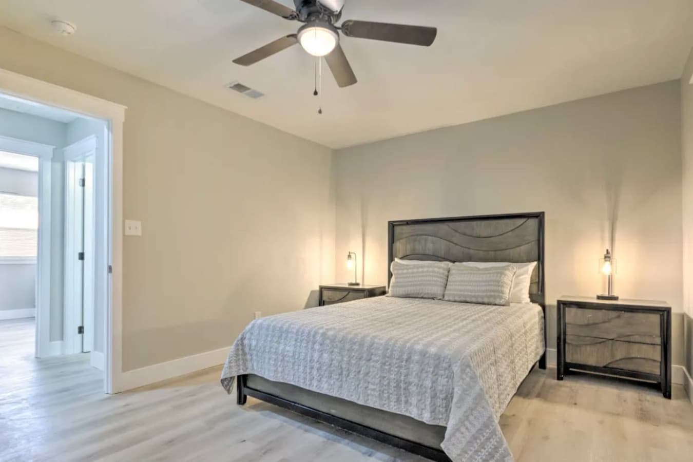 This serene bedroom offers a peaceful escape with a cozy queen bed.