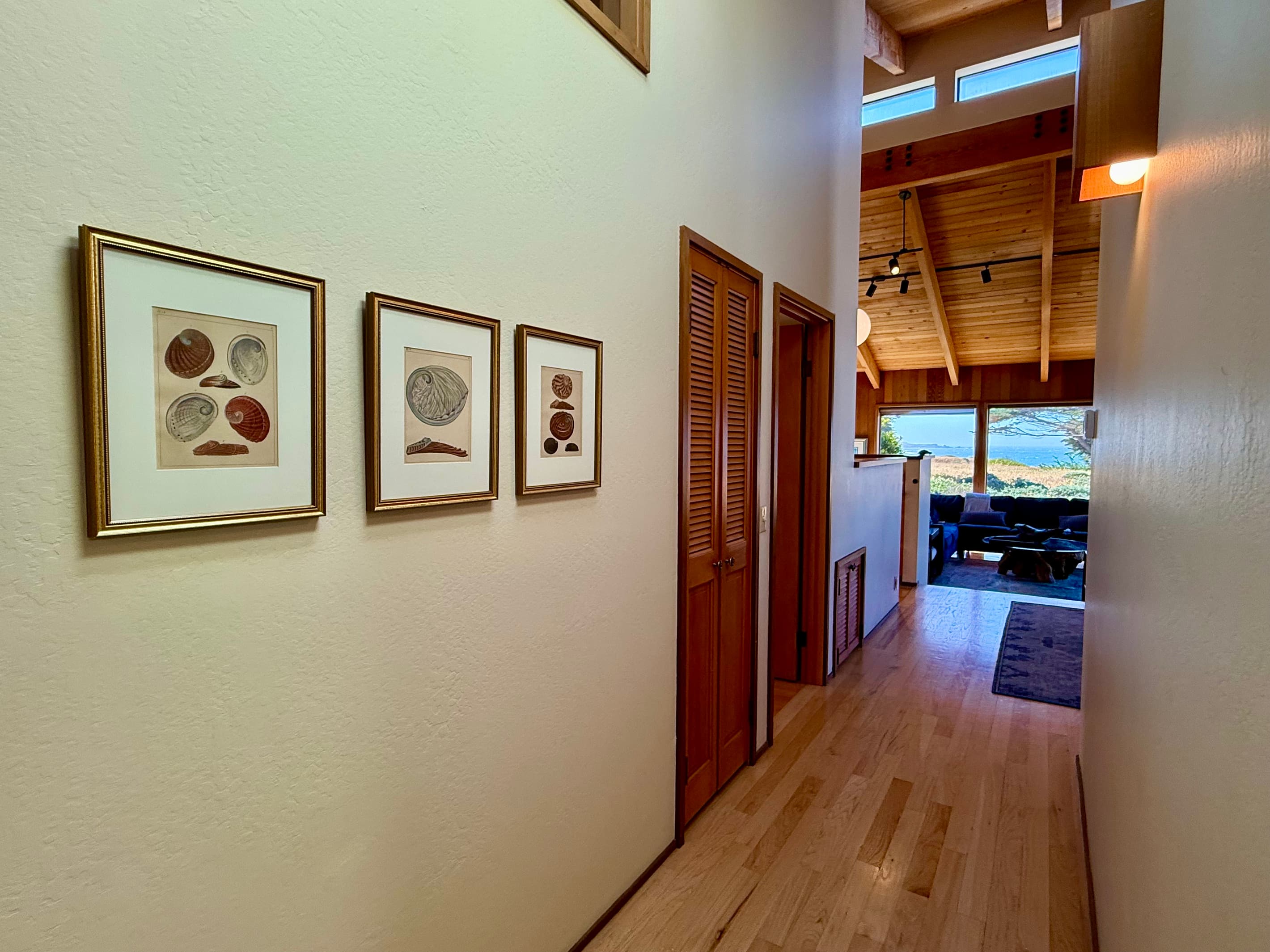 "I was absolutely enchanted by Abalone Prints in the hallway. I had never imagined art in that way." A trio of abalone shell lithographs by F. H. Martini installed June 2026. 
Some artwork decorates a home. Other artwork helps tell its story.