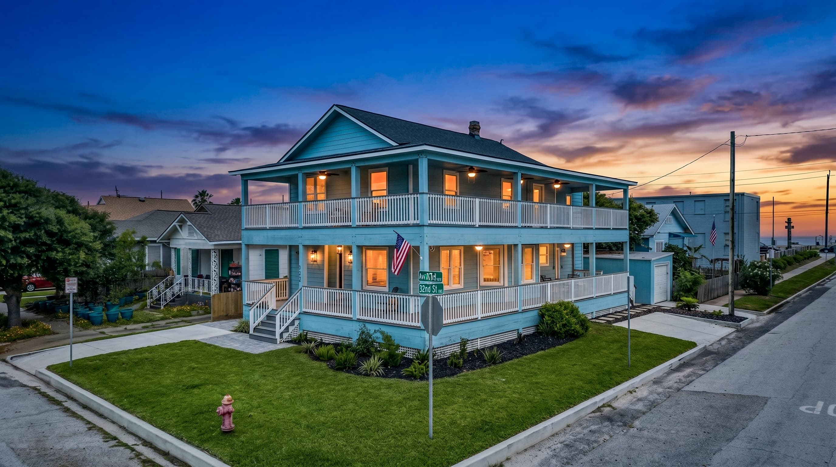 The Lookout at R½ glowing at golden hour — a beautifully restored Galveston Seawall home with wraparound decks on every level, steps from the beach and Pleasure Pier.