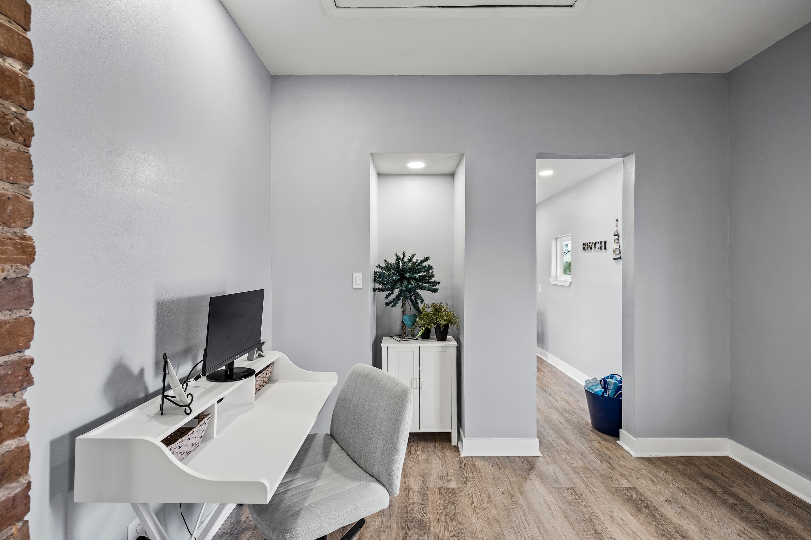 Work remotely from The Lookout at R½ — a full desk with monitor, exposed brick backdrop, and natural light. Extend your vacation when the office comes with you.