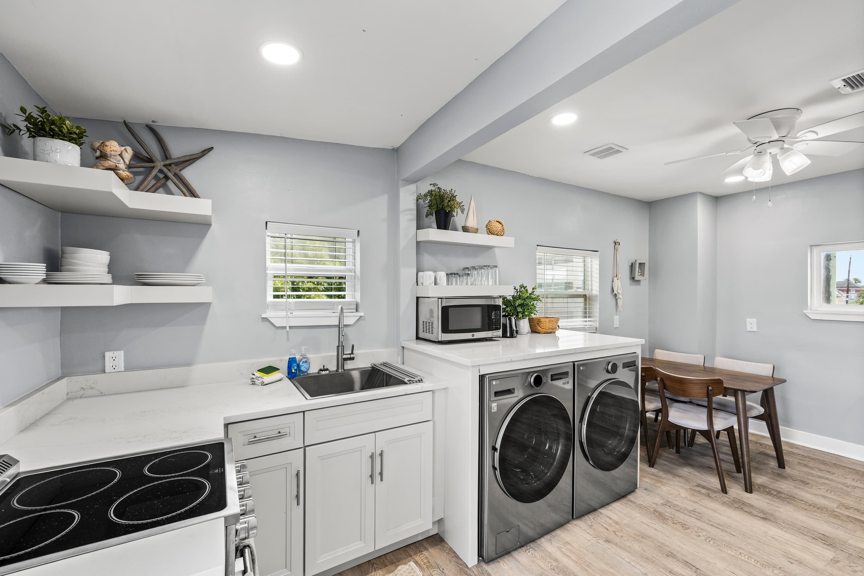 Fully equipped kitchen at The Lookout at R½ — full-size stove, in-unit washer and dryer, open shelving, and a dining area for the whole group. Built for longer stays.