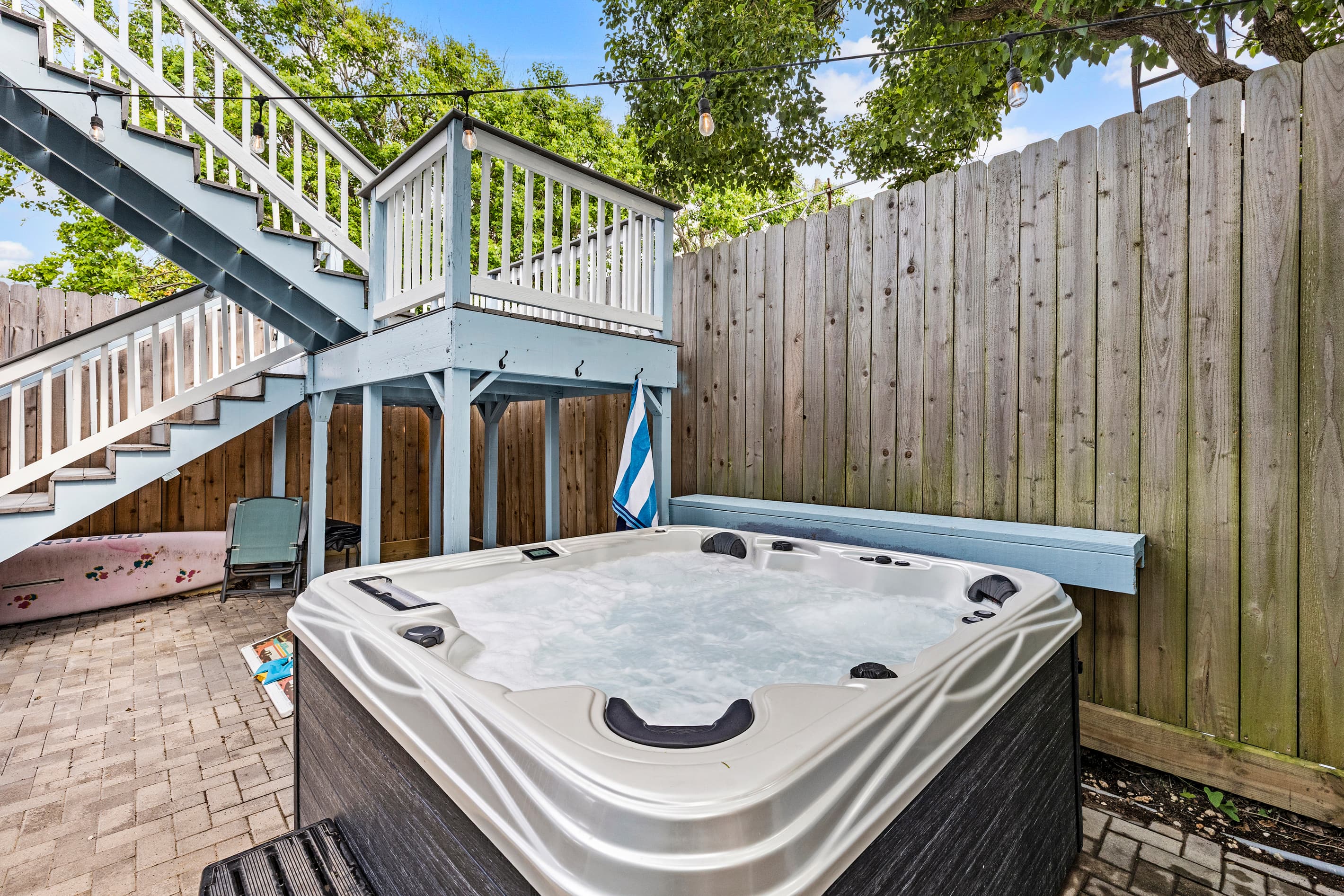 Private hot tub at The Lookout at R½ — jets, open sky, and a fully fenced courtyard for complete privacy. End every Galveston evening exactly like this.
