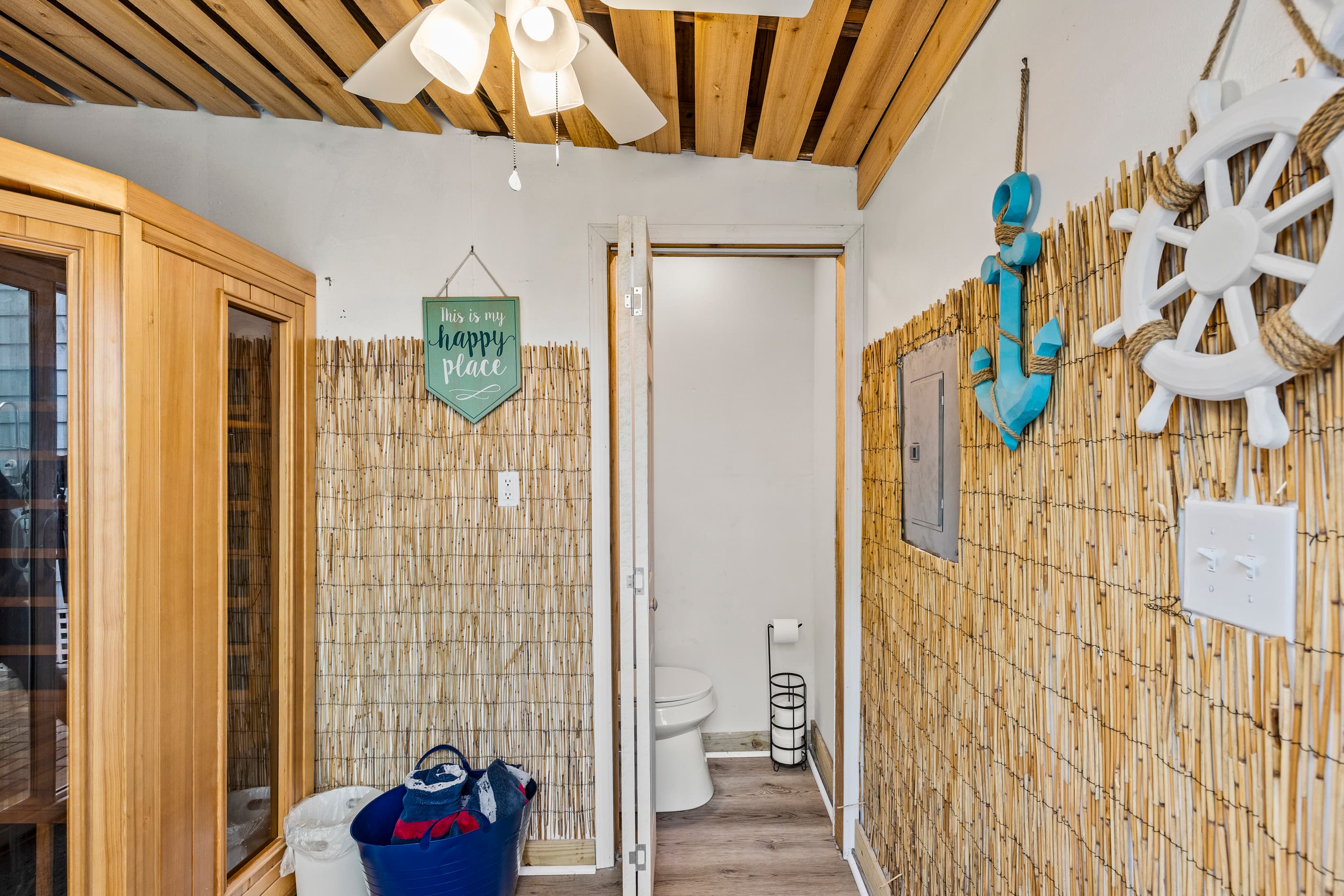 The outdoor spa area at The Lookout at R½ — sauna, private outdoor restroom, bamboo walls, and coastal nautical decor. Everything you need steps from the hot tub.