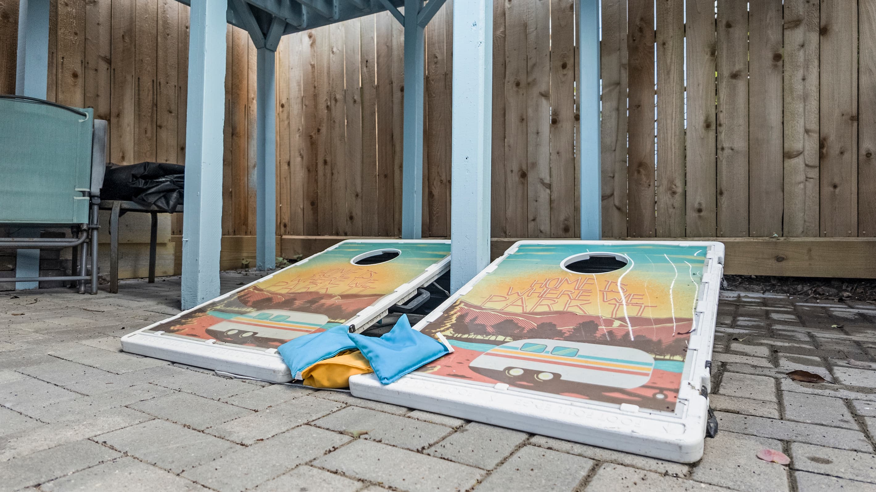 Cornhole in the private courtyard at The Lookout at R½ — a full set on the paver patio, ready for guests. Games, Gulf breezes, and cold drinks: the perfect Galveston afternoon.