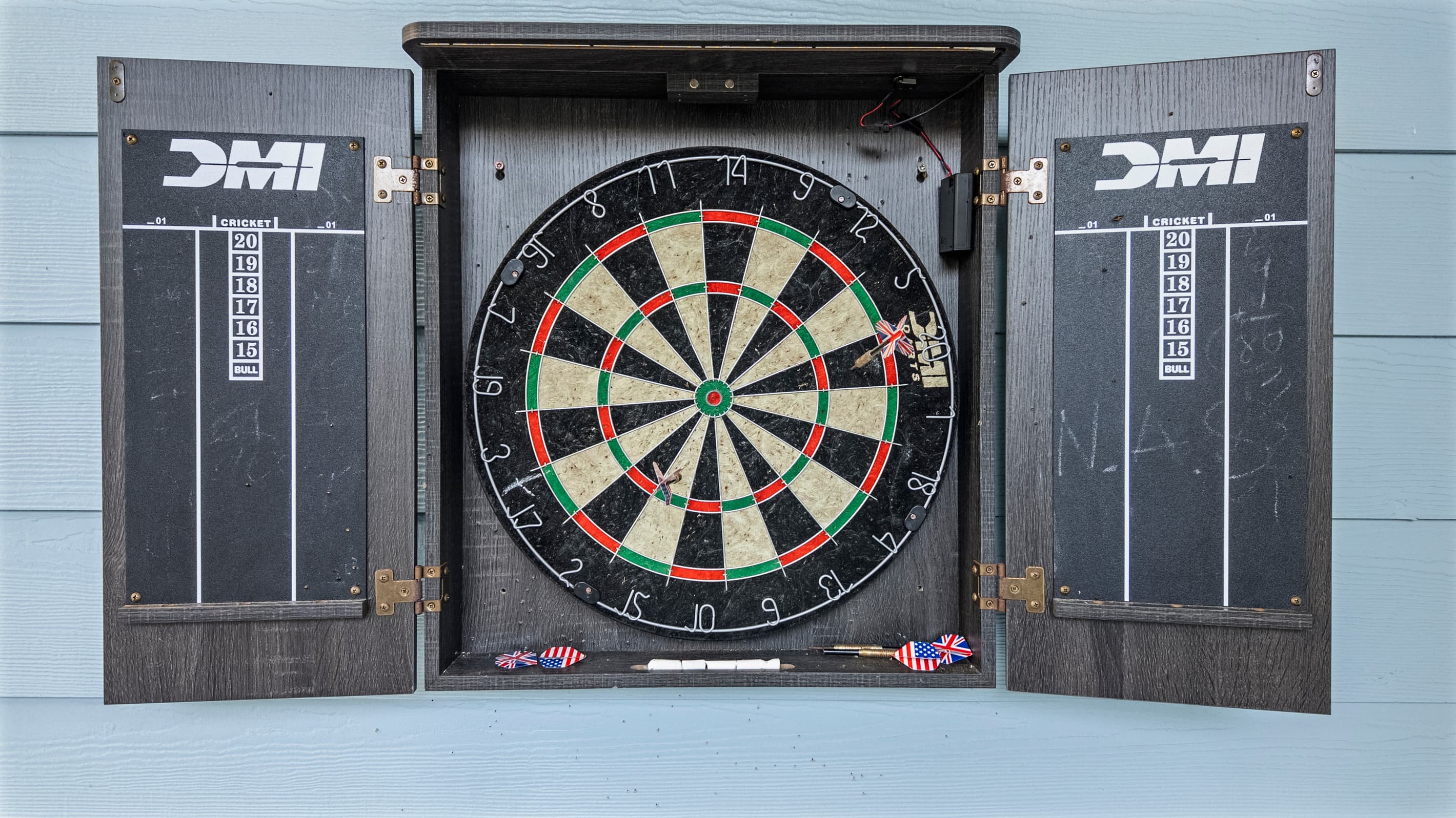 Regulation dartboard in the covered courtyard at The Lookout at R½ — challenge your group between hot tub rounds. Games always available, no reservations required.