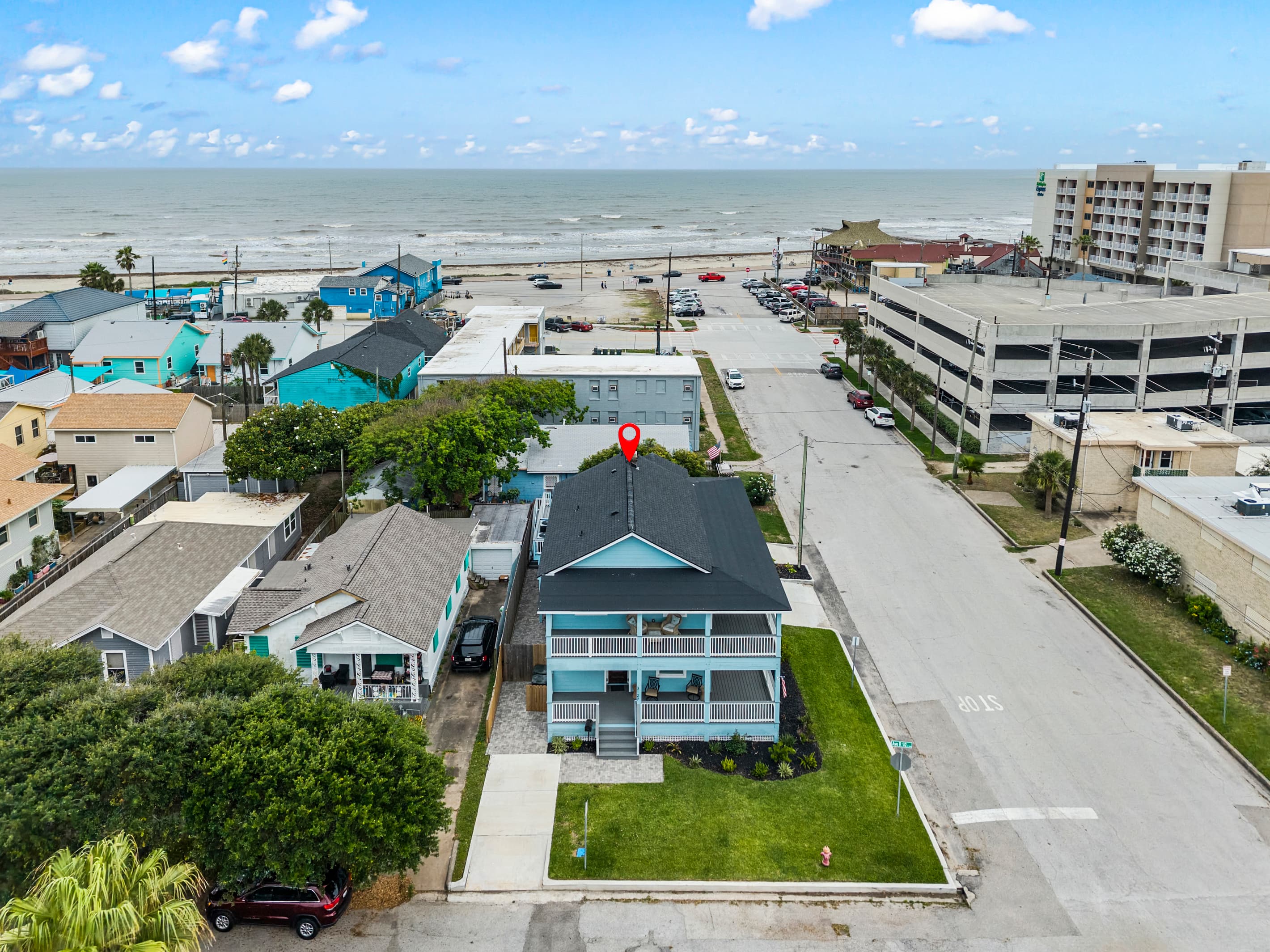 The Lookout at R½ (pinned) steps from the Galveston Seawall — the beach is right there, visible from the property and walkable in under 2 minutes.