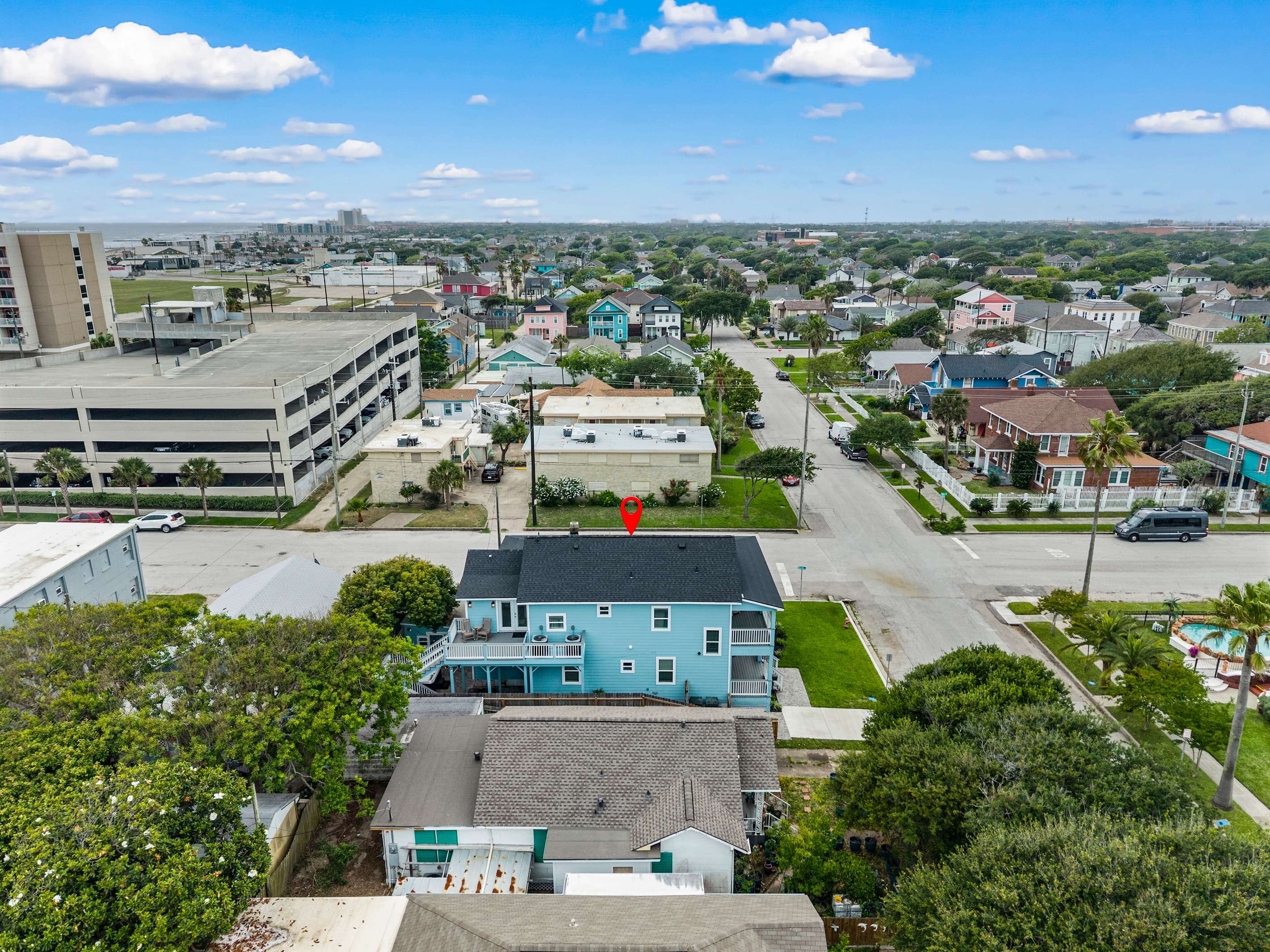 The Lookout at R½ (pinned) just off the Galveston Seawall — the beach parking structure and Gulf of Mexico visible right next door. The beach is genuinely steps away.