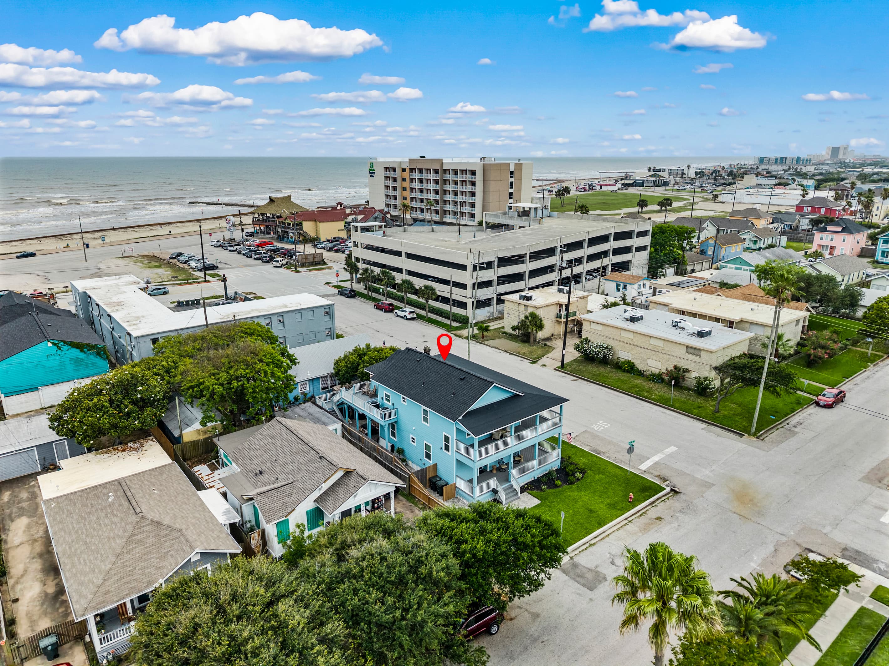 The Lookout at R½ (pinned) at the edge of the Galveston Seawall — Gulf views from the air and beach access on foot. Everything that makes Galveston worth the trip, right outside.