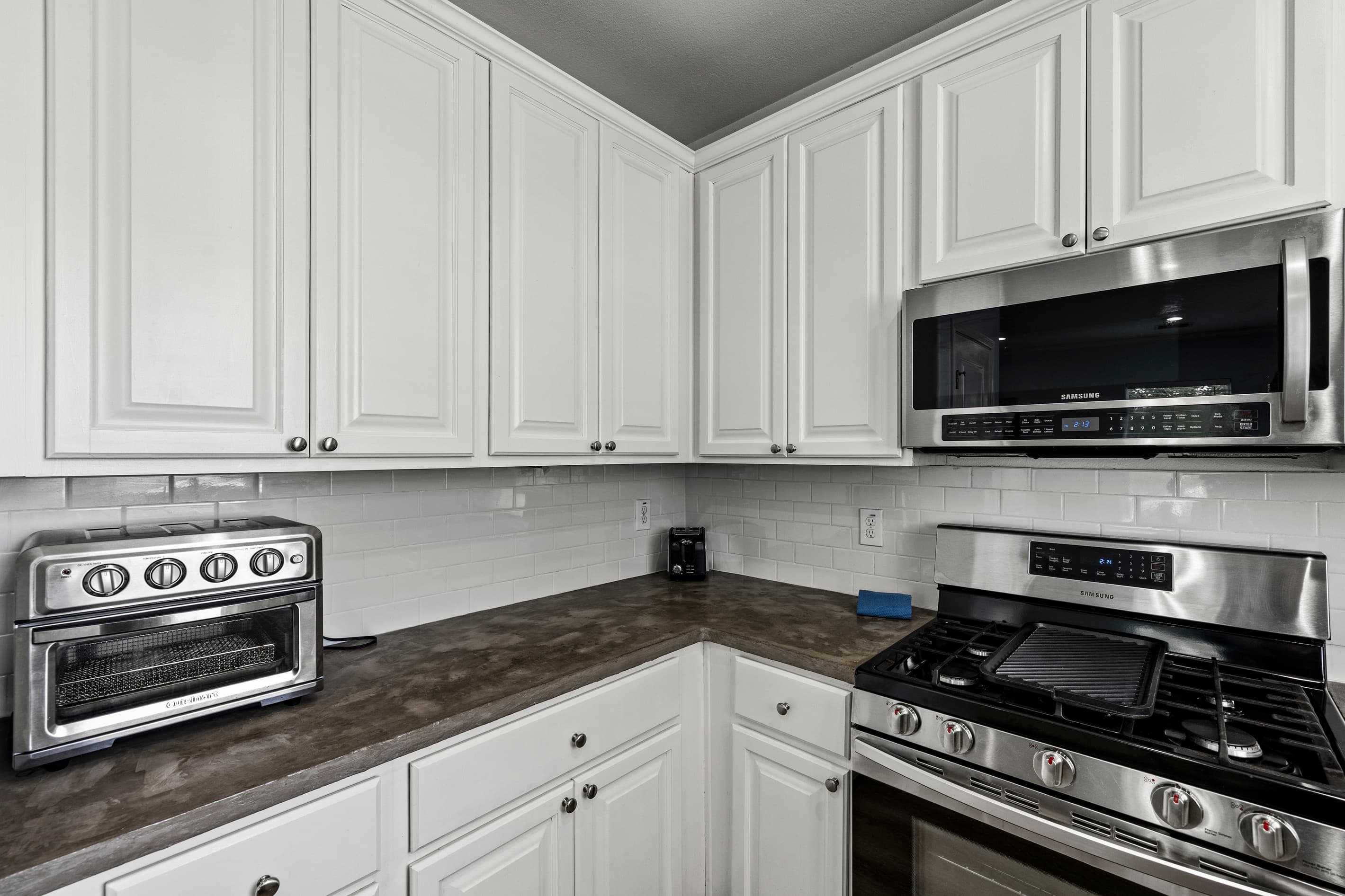 Kitchen appliances at Summer Bliss — stainless gas range, microwave, and ample counter space for cooking real meals during your Galveston stay.