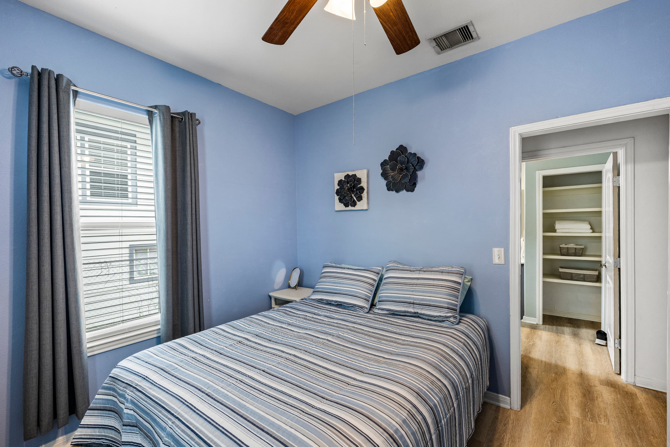 Another angle of the master suite at Summer Bliss — queen bed, ceiling fan, and closet storage. Step-free access on the main level — ideal for guests who prefer everything on one floor.