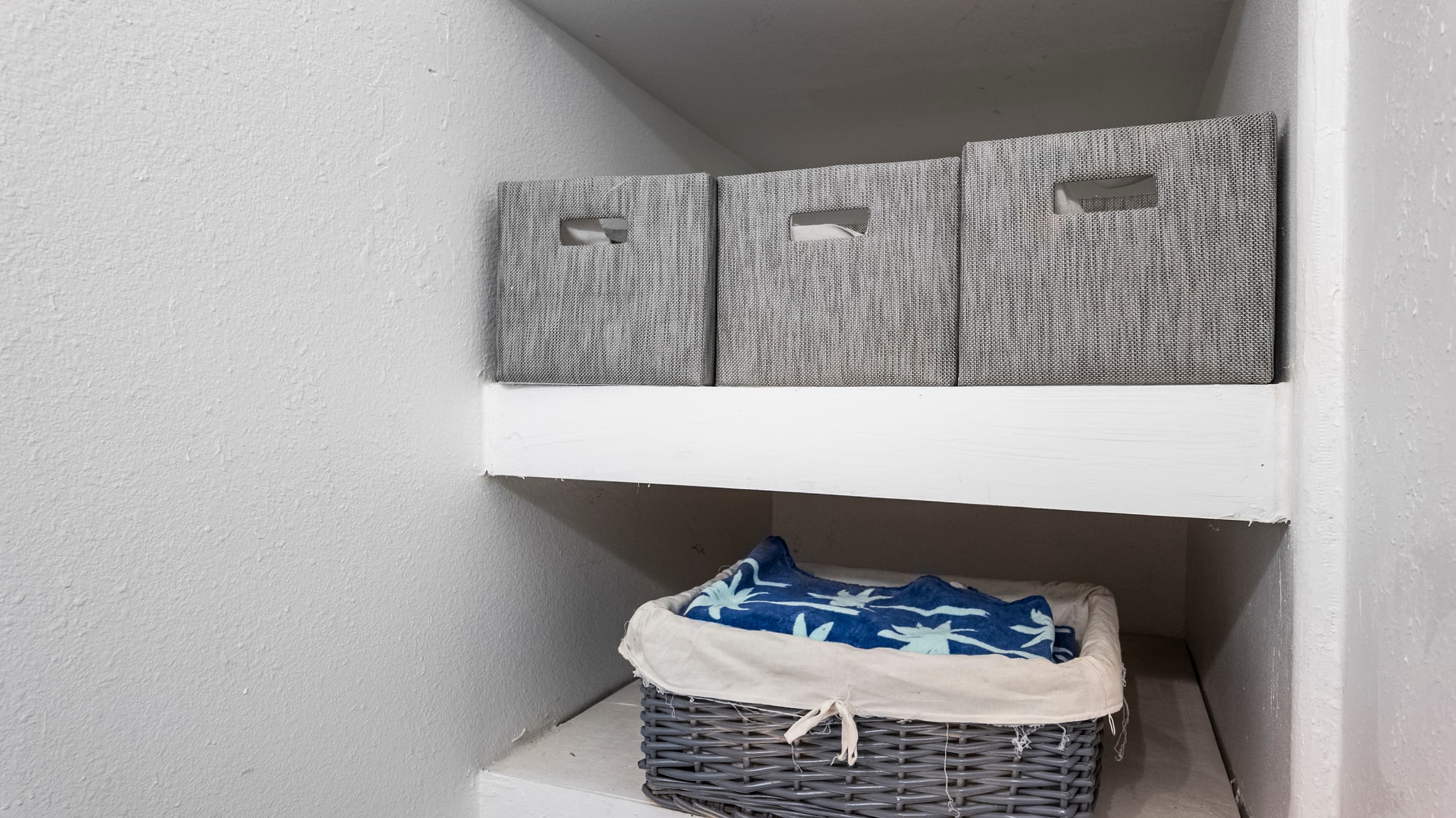 Storage in the half bath at Summer Bliss — tidy bins keep essentials organized and accessible on the main level. Convenient after beach days.