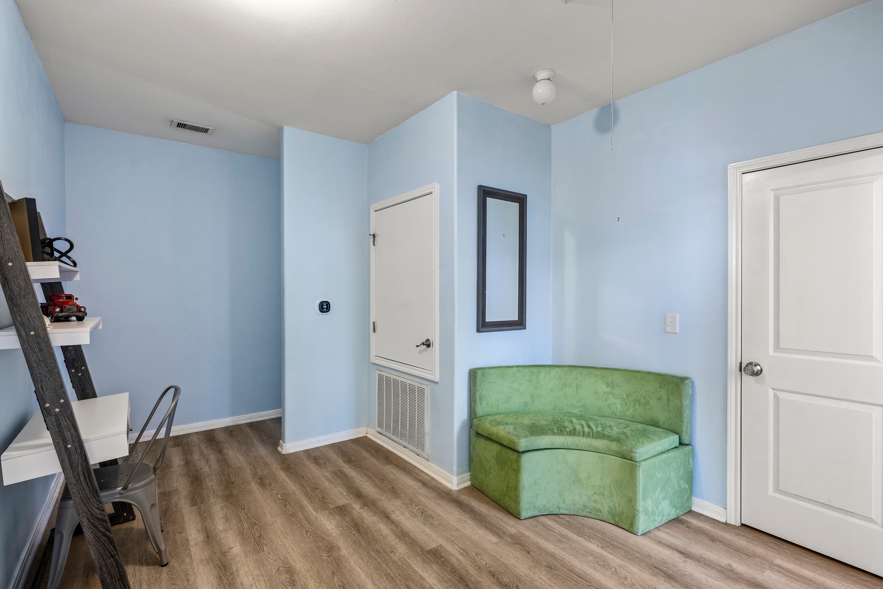 The second-level landing at Summer Bliss — extra seating, storage, and a workstation at the top of the stairs. Everything you need right where you need it.