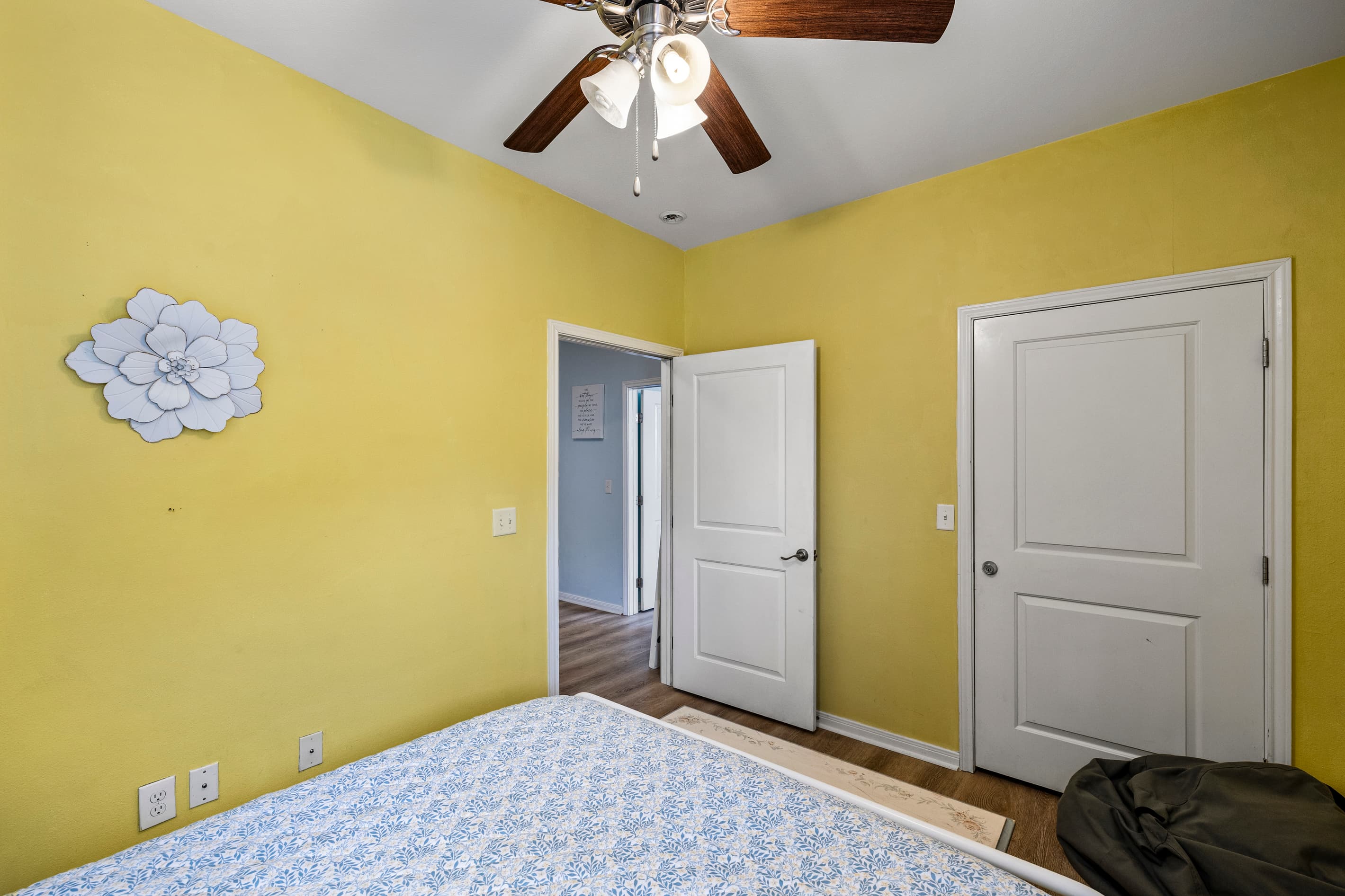 Another angle of Bedroom 2 at Summer Bliss — queen bed, ceiling fan, and a bright yellow room that keeps the vacation energy going.