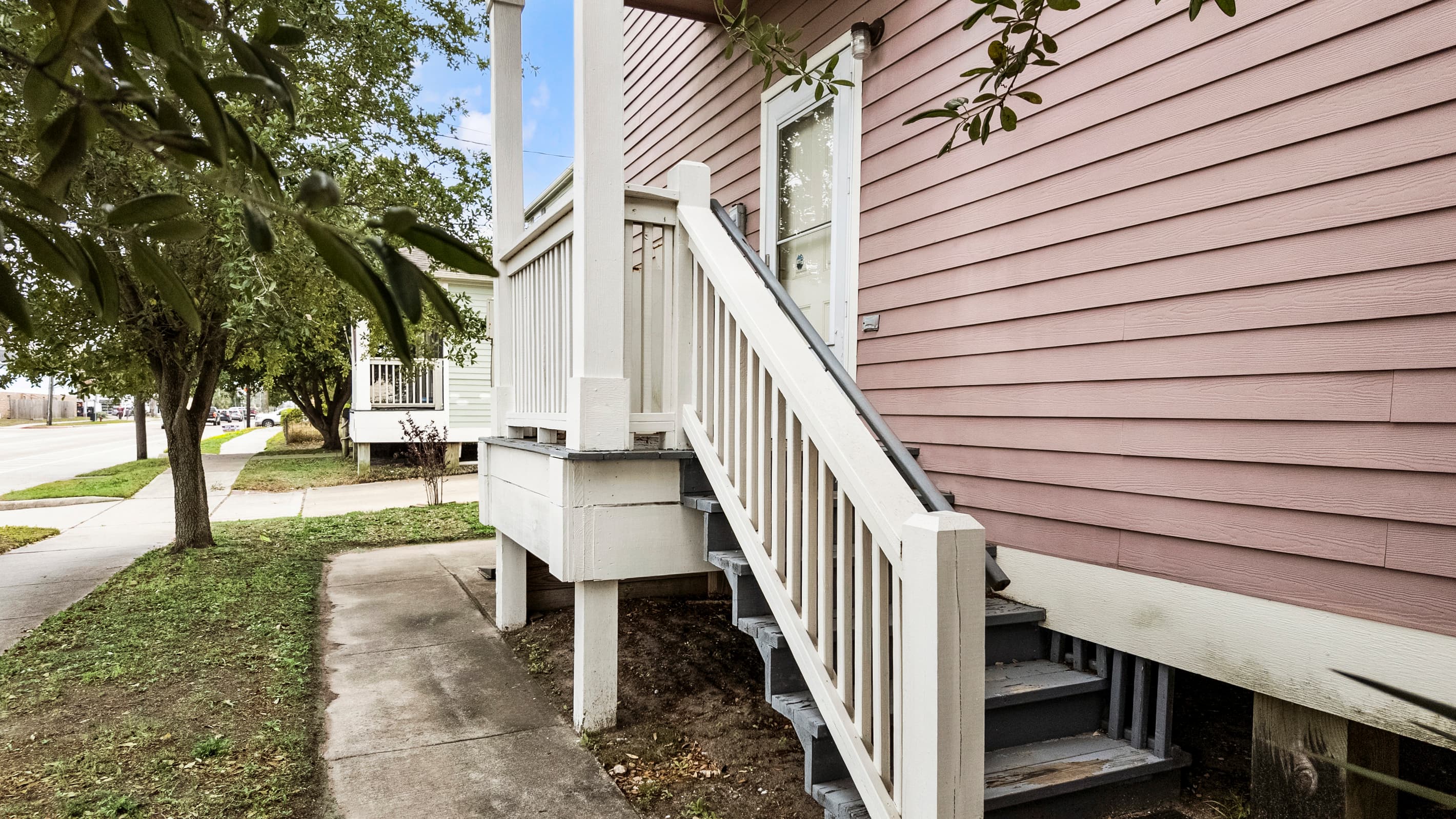 Summer Bliss sits on a full corner lot at R and 53rd Street — plenty of outdoor space surrounding the property, with two-car private driveway parking available for guests.