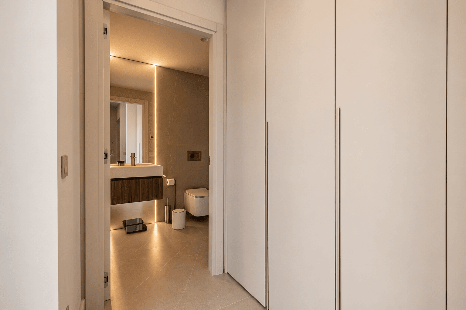 AZULIS DelleTerme Suites Walk through wardrobe with ample storage and luxury en suite bathroom by RE