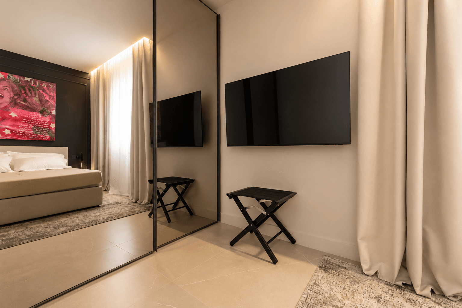 AZULIS DelleTerme Suites Bedroom mirrored wardrobe with wall mounted smart TV by RENTAL12