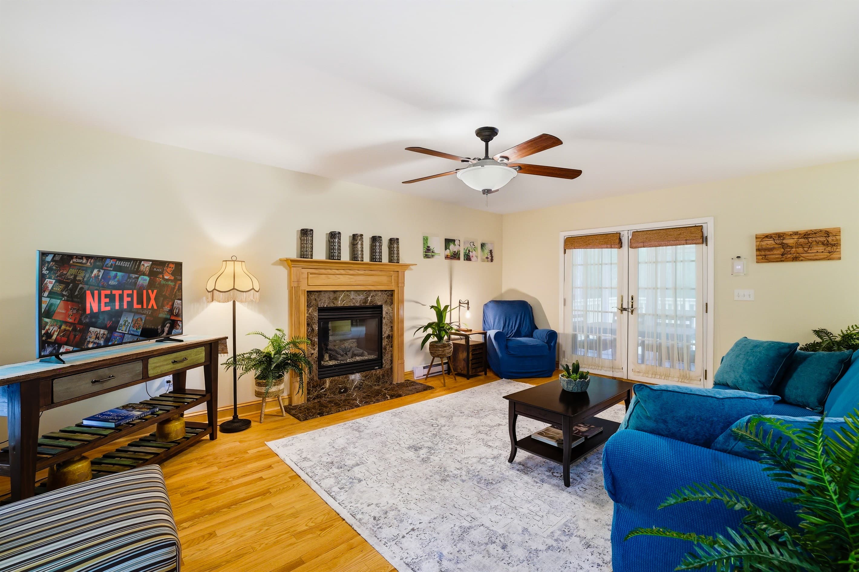 Living room with comfortable seating, propane fireplace and TV