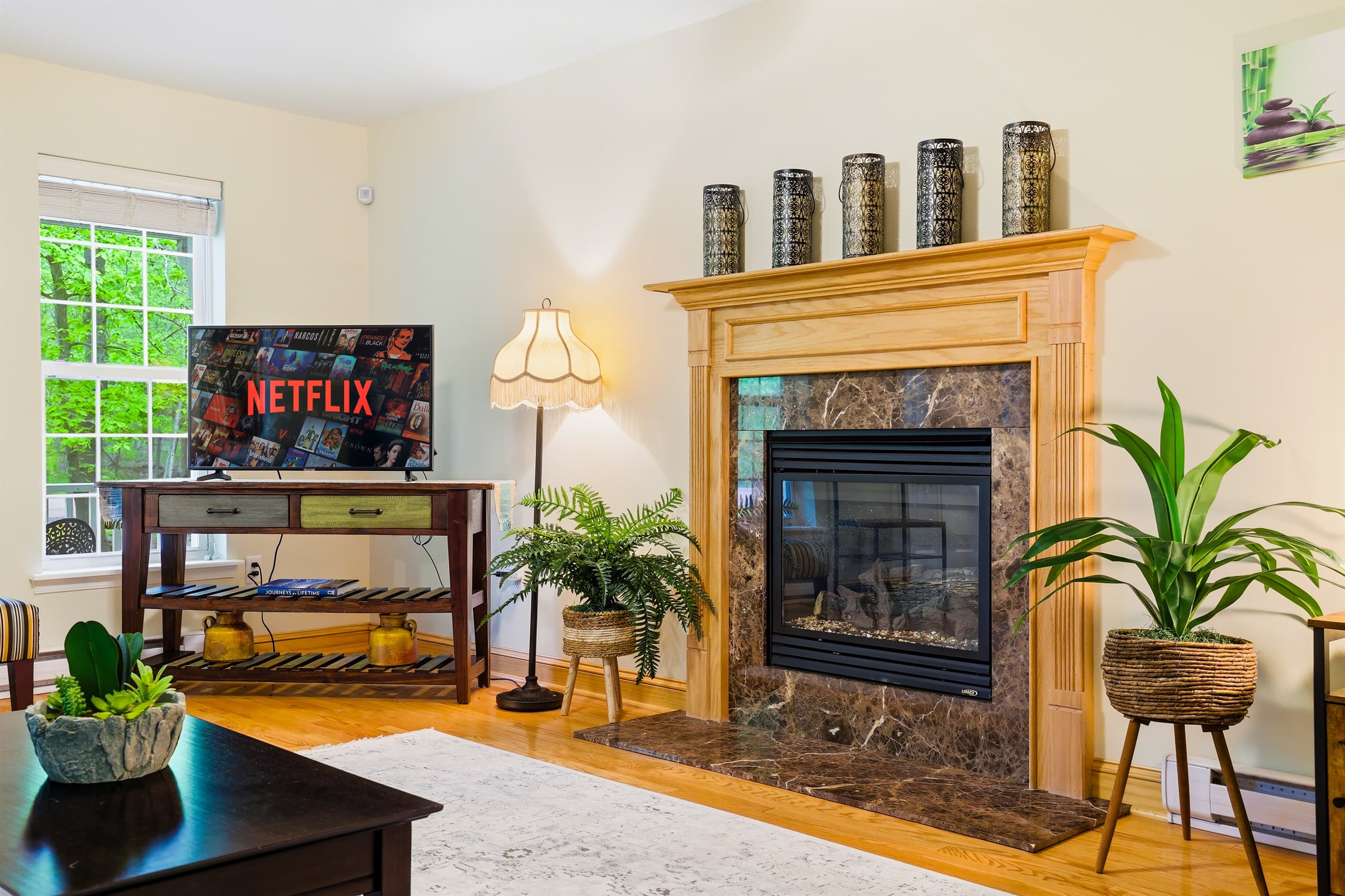 Living room with comfortable seating, propane fireplace and TV