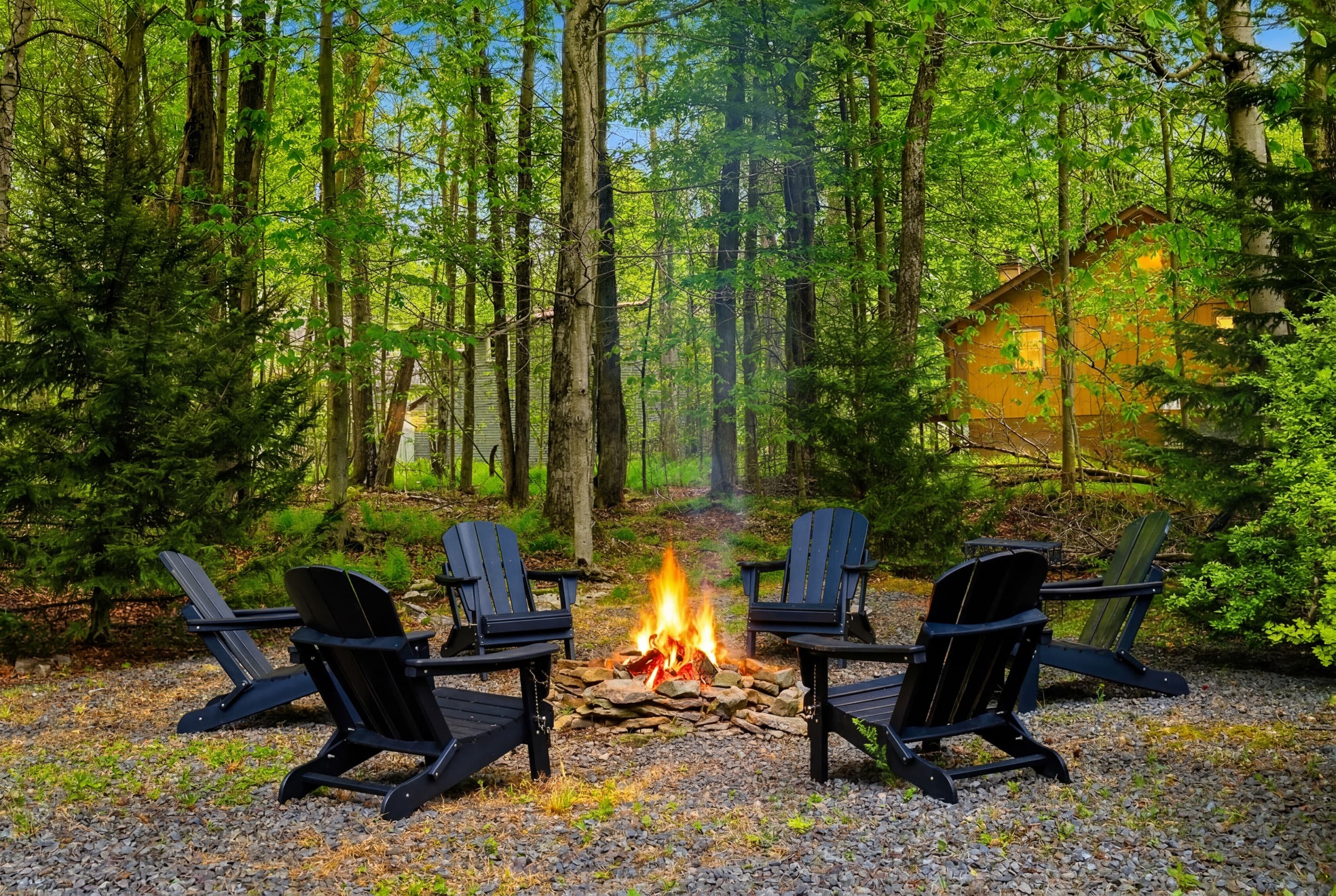 Relax in the backyard featuring a firepit and seating