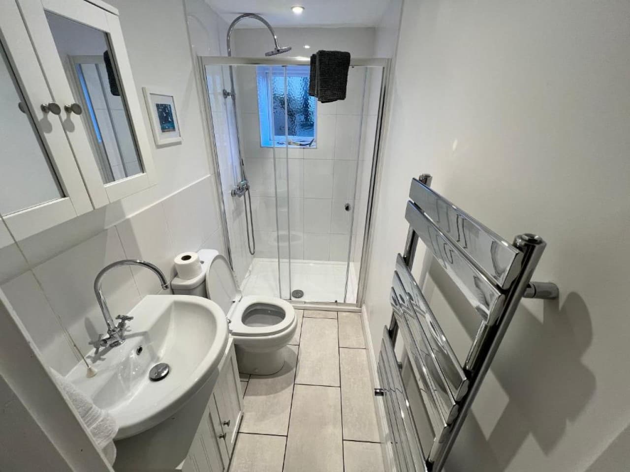 Bathroom - glass rain shower and handheld, heated towel rail, sink, toilet