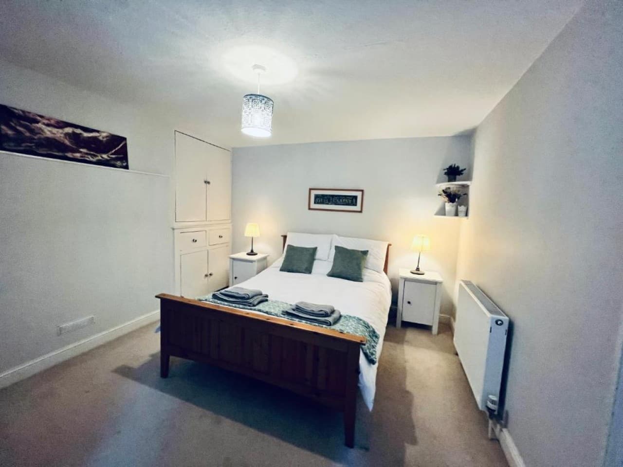Bedroom 1 - double bed, built-in wardrobe, desk with potted plant (angle 4)