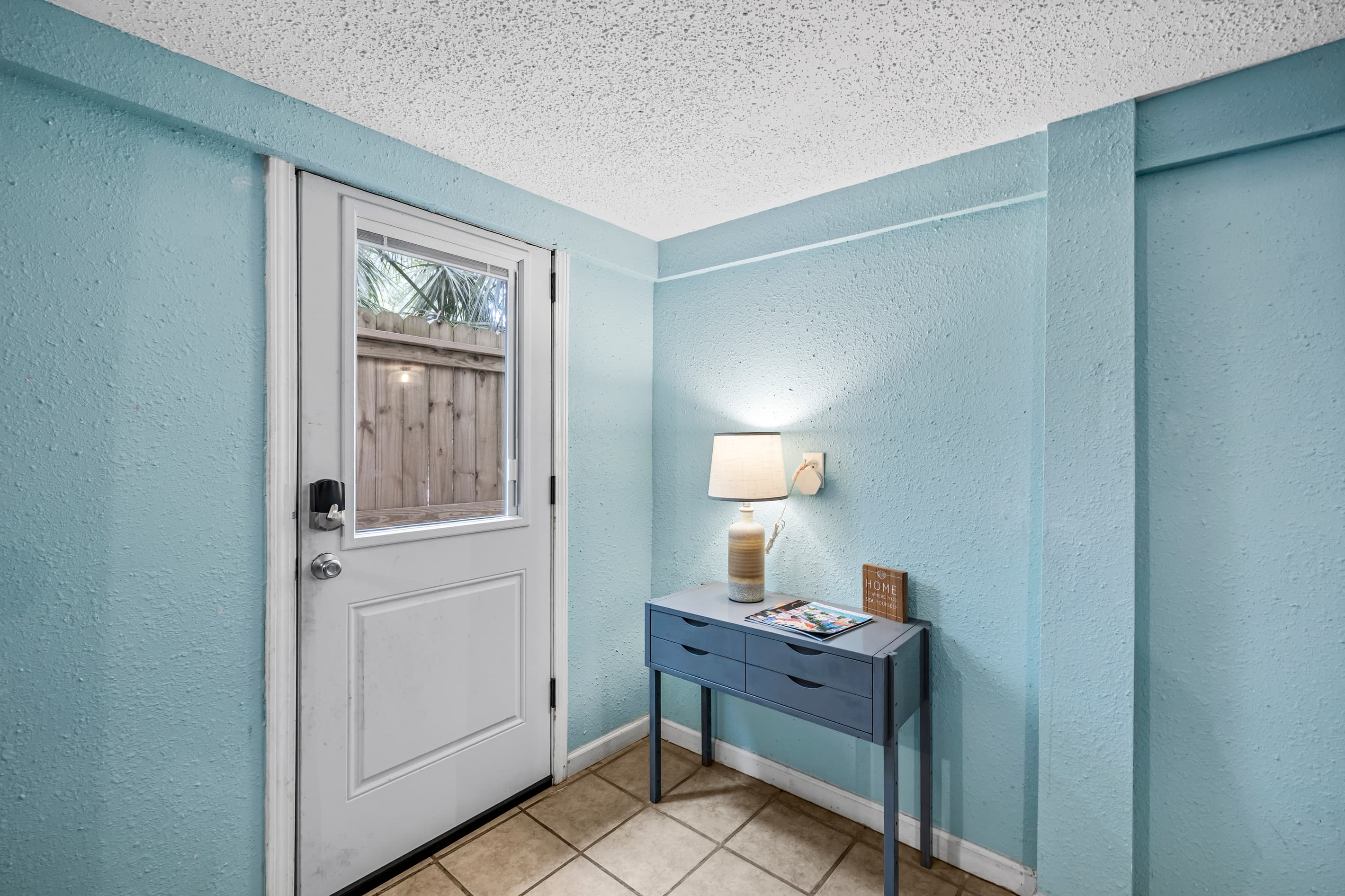 A welcoming entry sets the tone — original hardwood floors, teal walls, and a warm sense of historic Galveston charm from the moment you arrive.