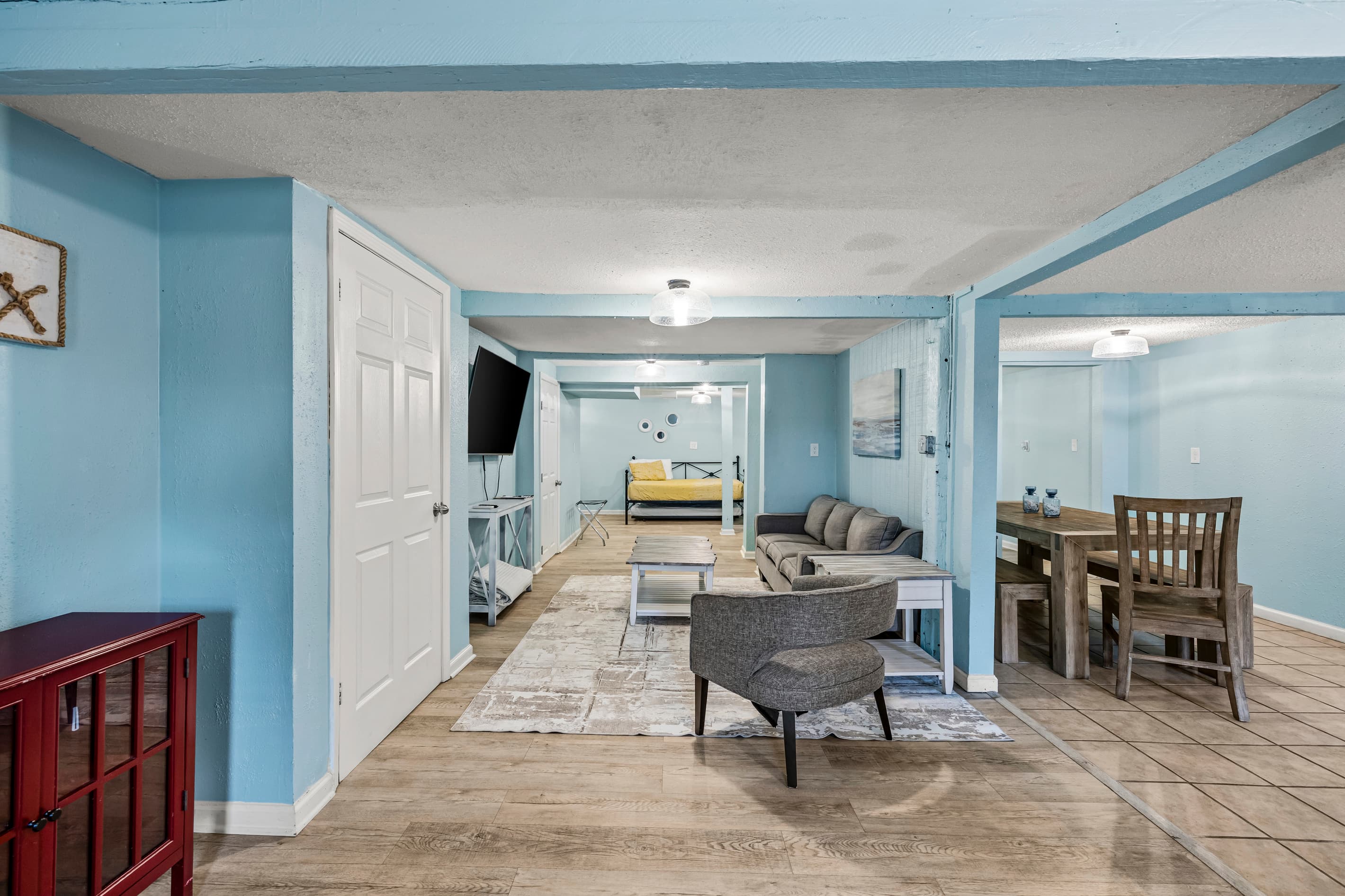 Sink into the comfortable living area after a day on the beach — plush seating, smart TV, and open views of the entire studio space await.