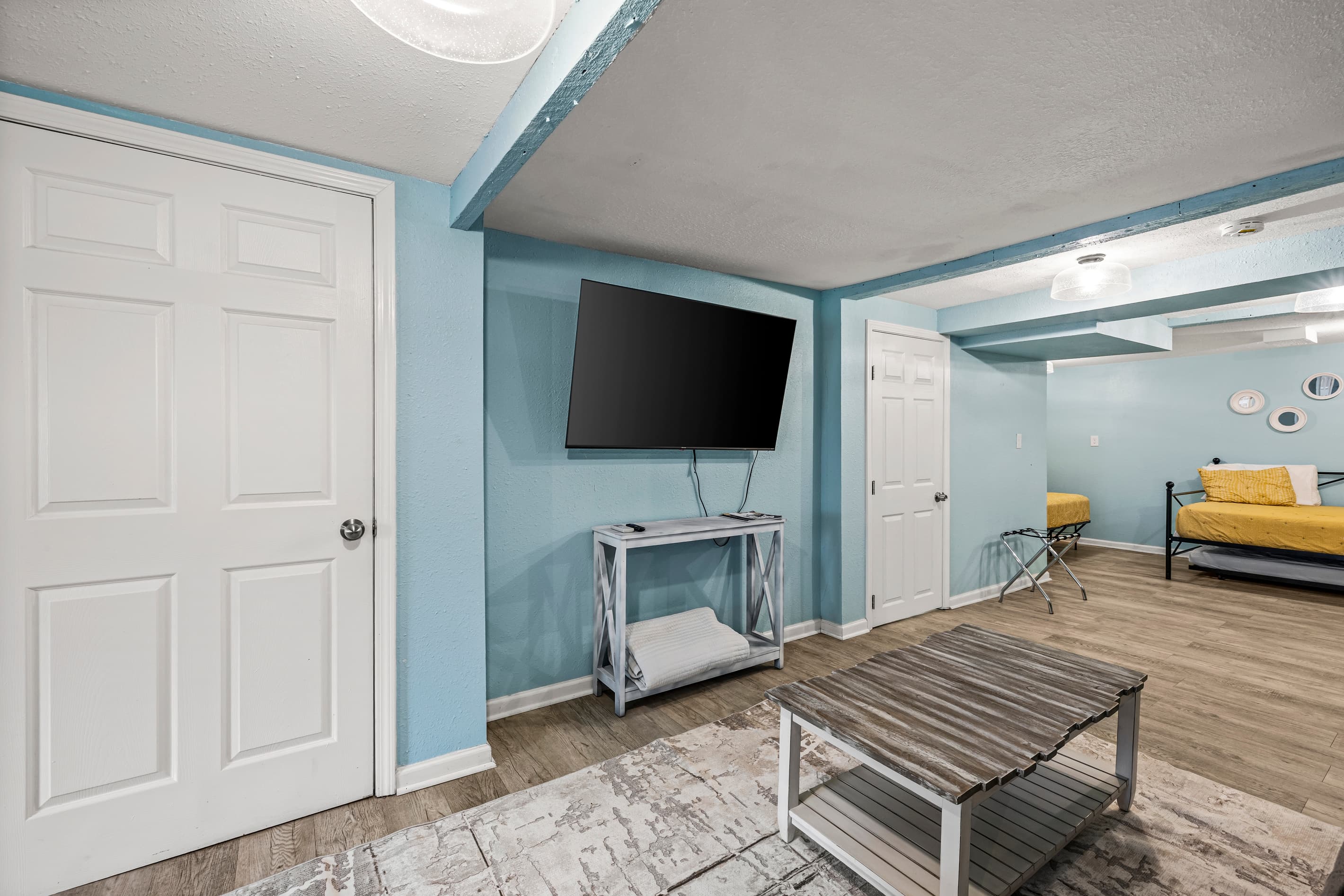 Unwind with your favorite show in the spacious living area — flat-screen TV, comfortable couch, and all the comforts of home in a historic Galveston setting.