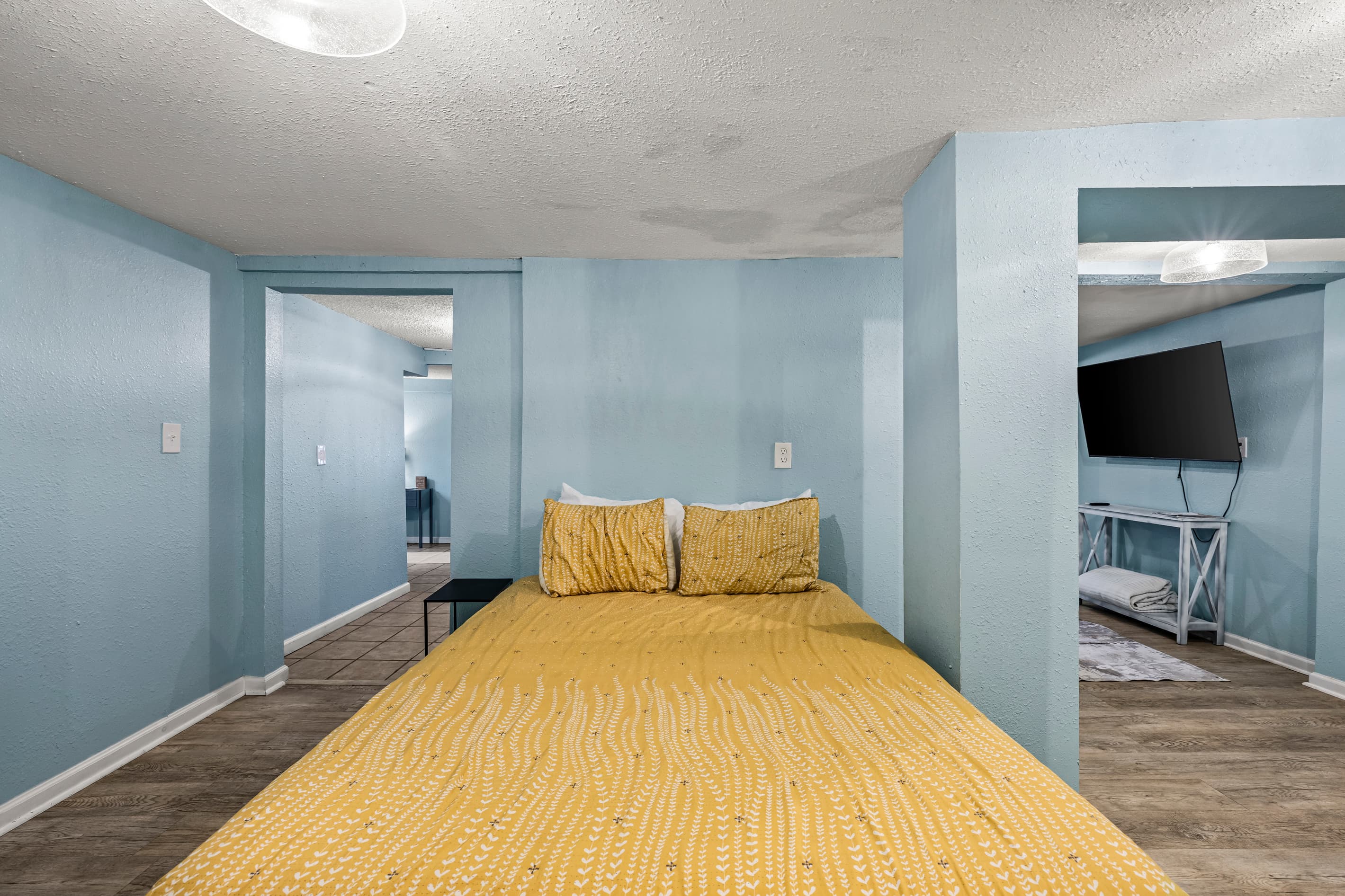 The main bathroom features a full shower and tub with quality fixtures — plus an in-unit washer and dryer for comfortable extended stays in Galveston.