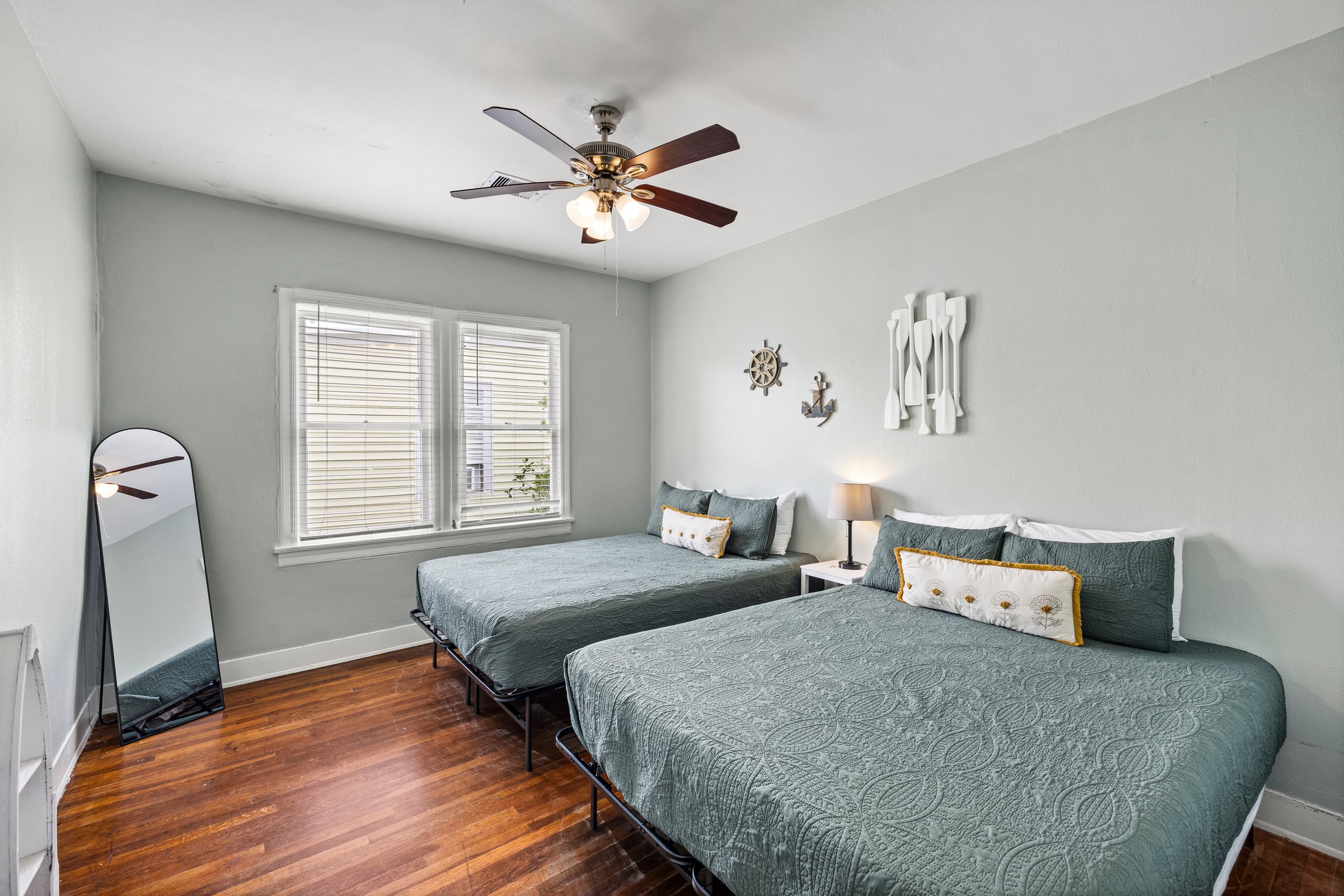 The second bedroom at Starboard at M features two queen beds — quality linens and plenty of space for the whole group to rest well.
