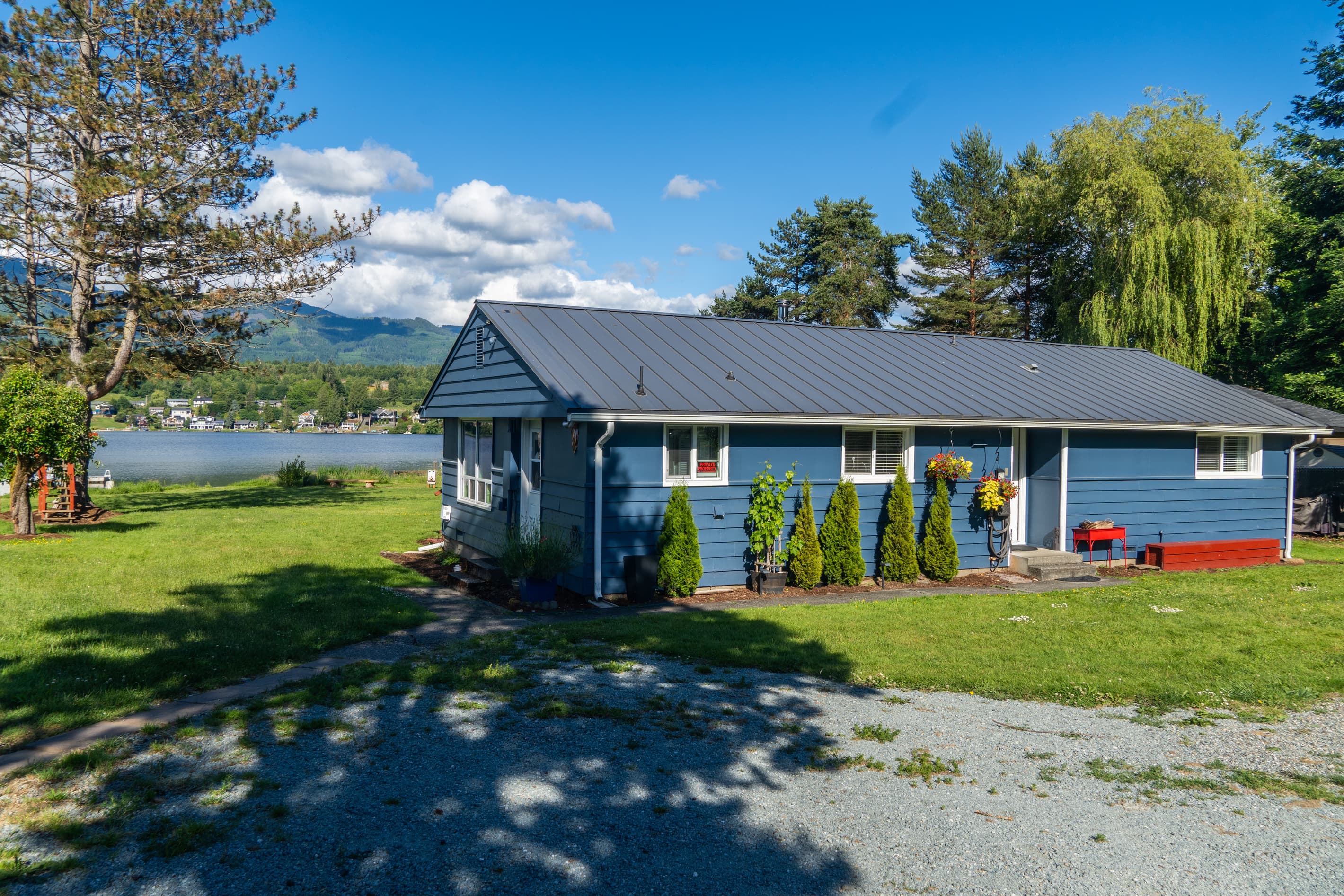 Tucked among the trees, this charming lake home offers a peaceful retreat just steps from the water. With ample parking, easy access, and a welcoming entrance, it's the perfect home base for your Big Lake getaway.