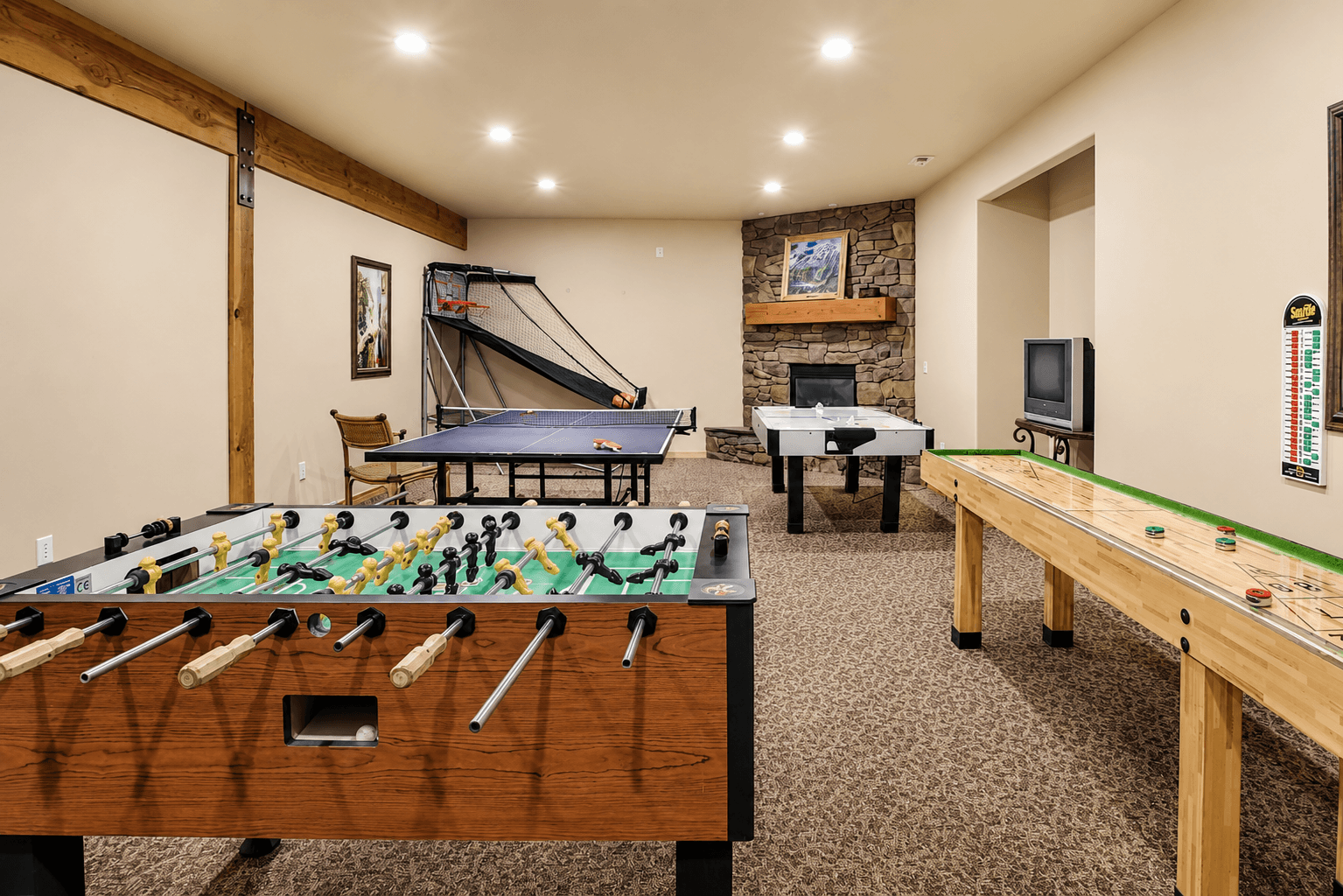 Clubhouse game room with ping pong, foosball, air hockey, and shuffleboard.
