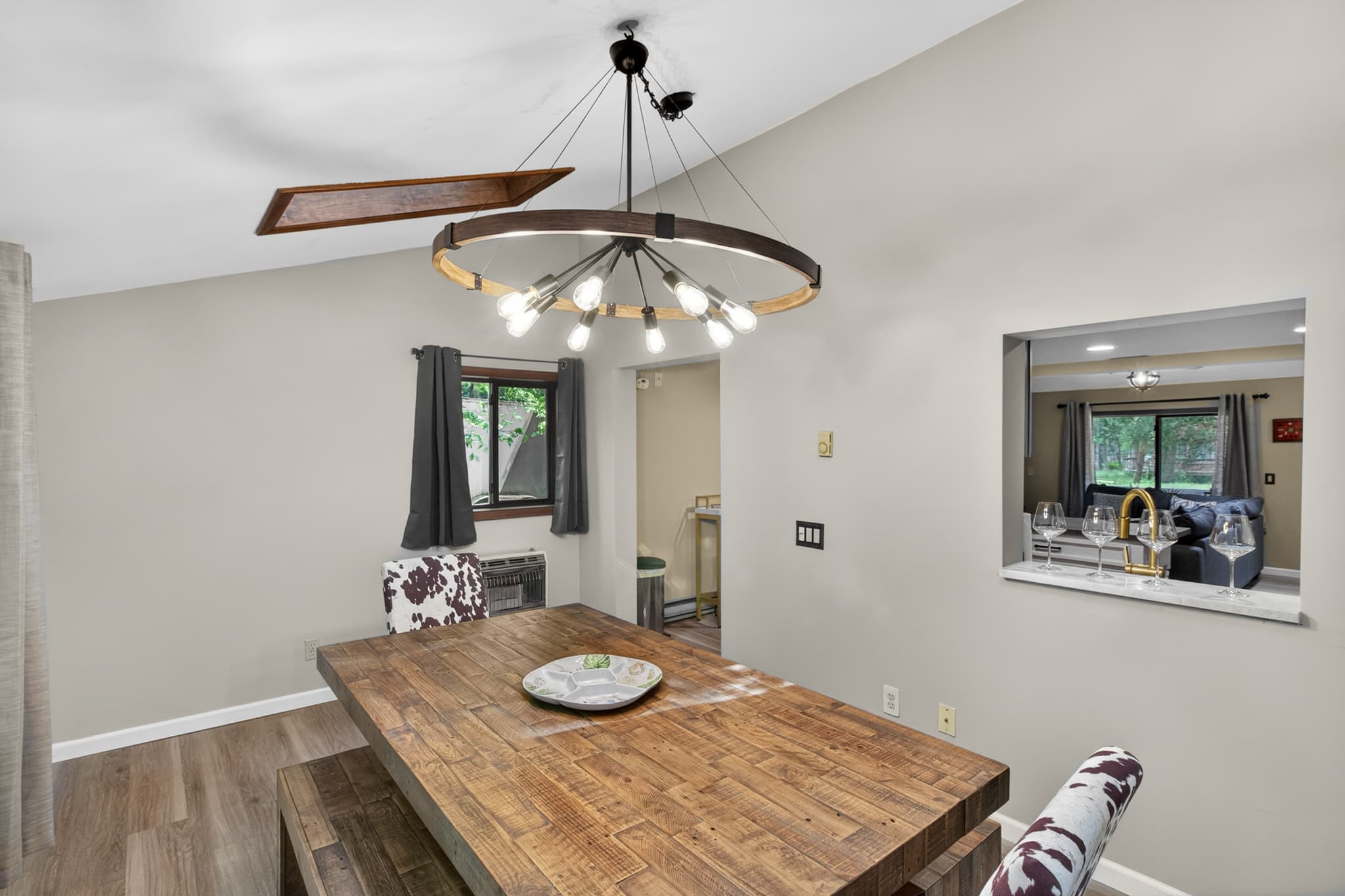 Dining room with table and seating. Exit to rear porch with BBQ grill and backyard