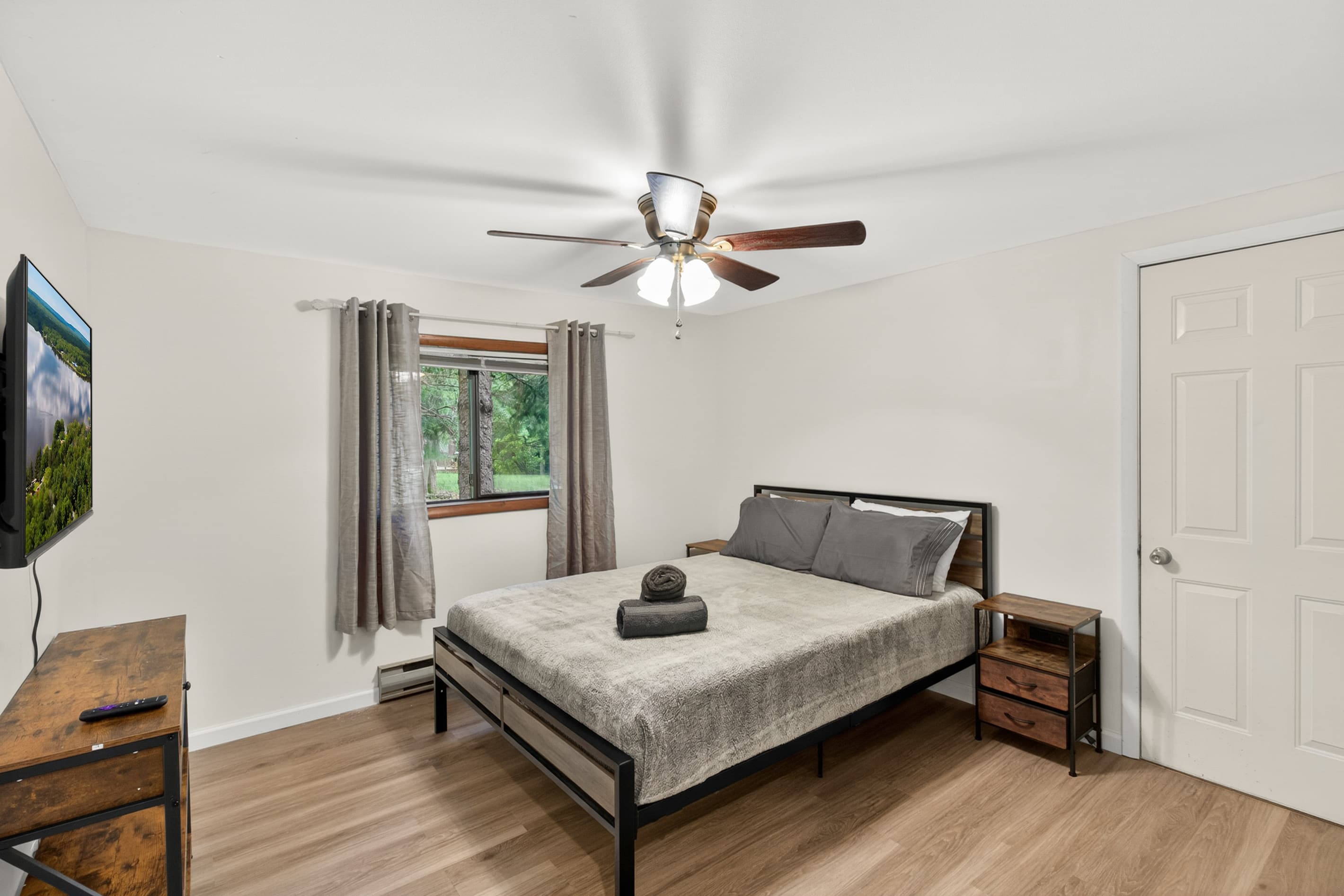 Bedroom with queen bed and Roku TV, on first floor