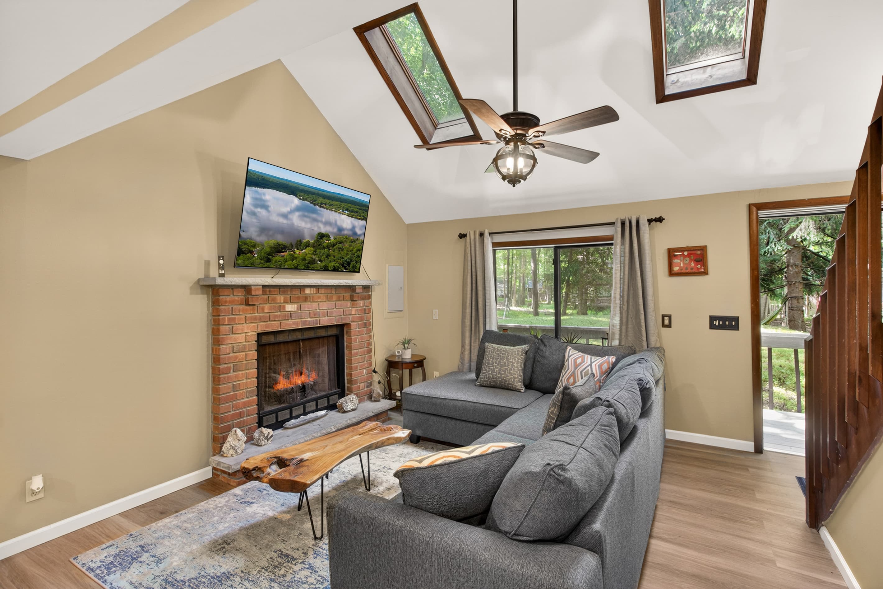 Living room with smart TV and comfortable sectional. Propane fireplace for colder months