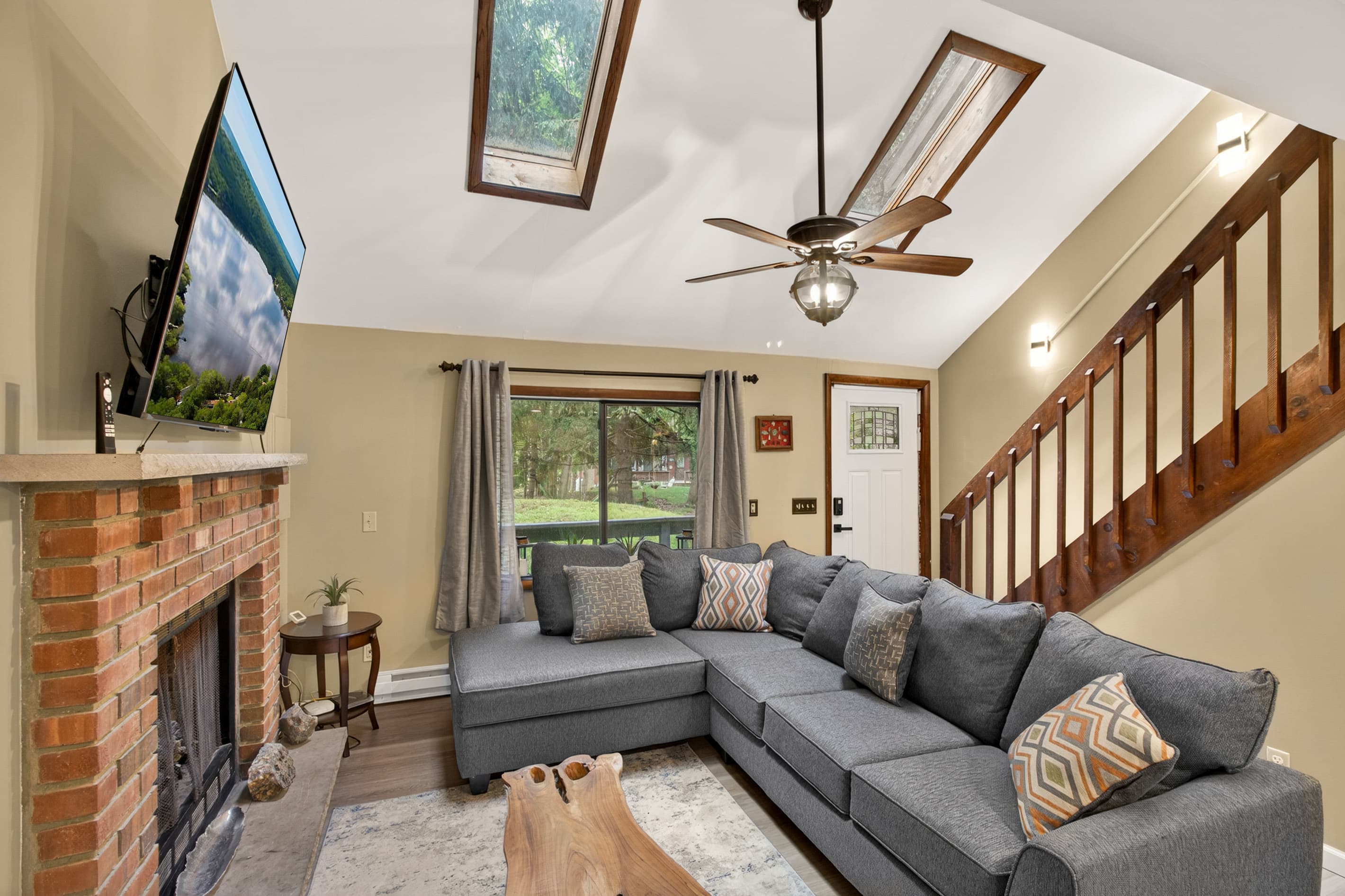 Living room with smart TV and comfortable sectional. Propane fireplace for colder months
