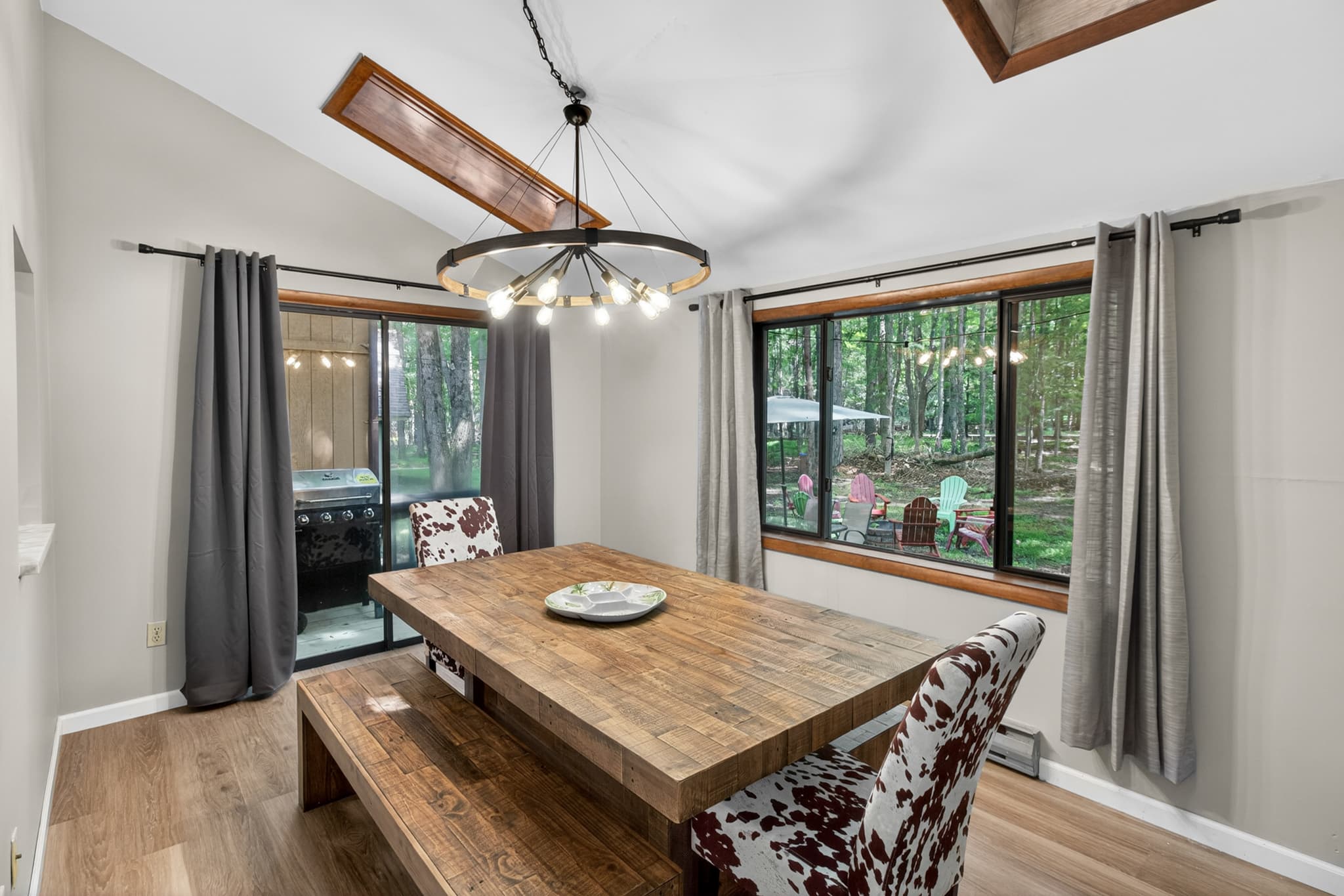 Dining room with table and seating. Exit to rear porch with BBQ grill and backyard