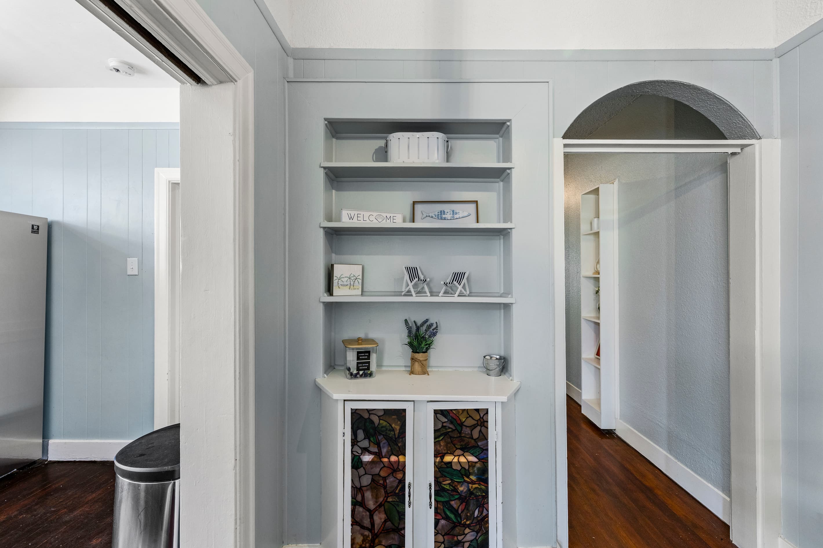 A fully equipped kitchen with crisp white cabinetry and stainless steel appliances — ready for everything from quick snacks to a full Gulf Coast dinner.