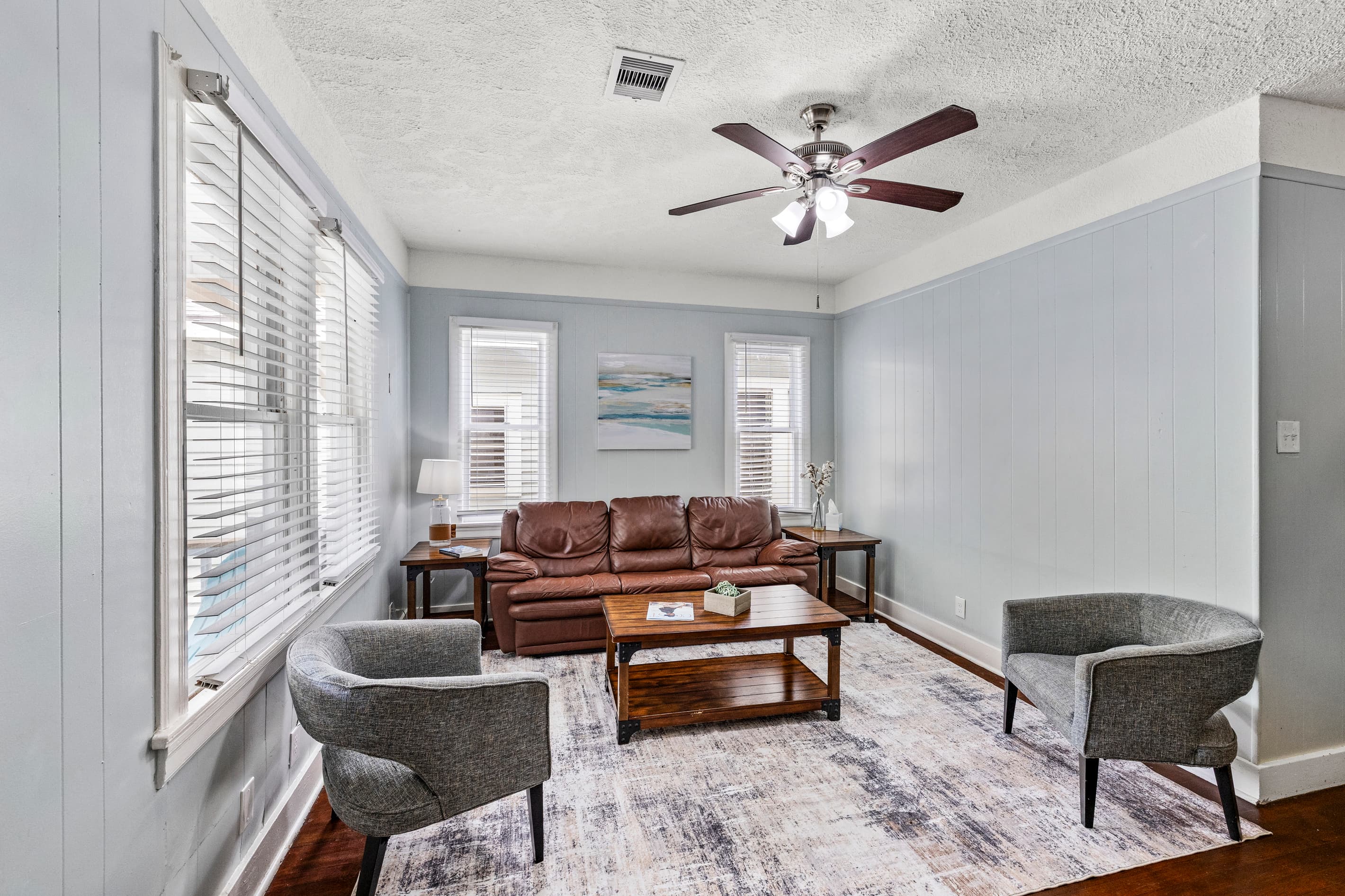 The open living area is made for gathering after a beach day — plush seating, great natural light, and a smart TV for movie nights in.
