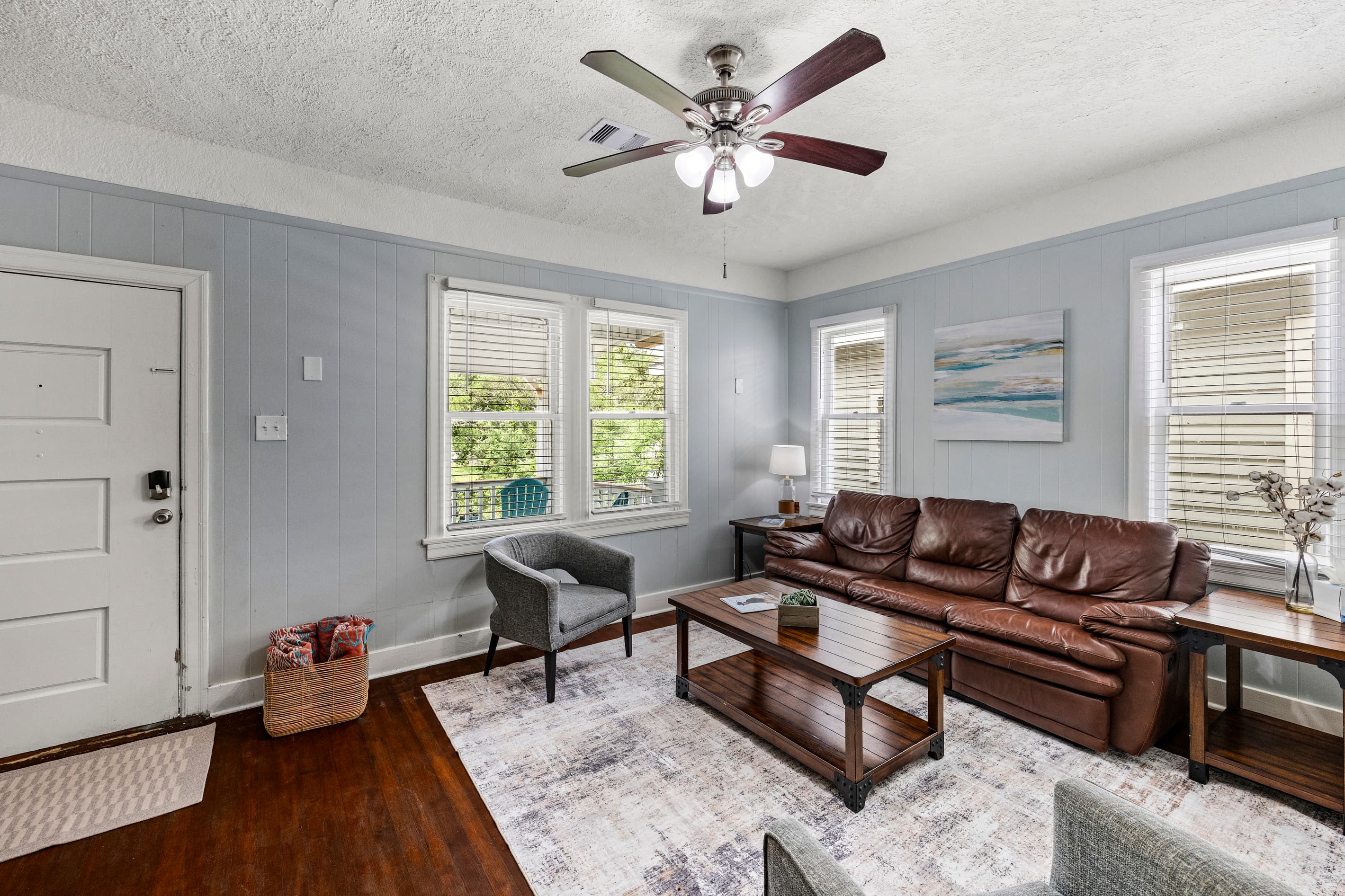 Sunlight pours into the living room through classic windows — a welcoming space to unwind with the whole group.