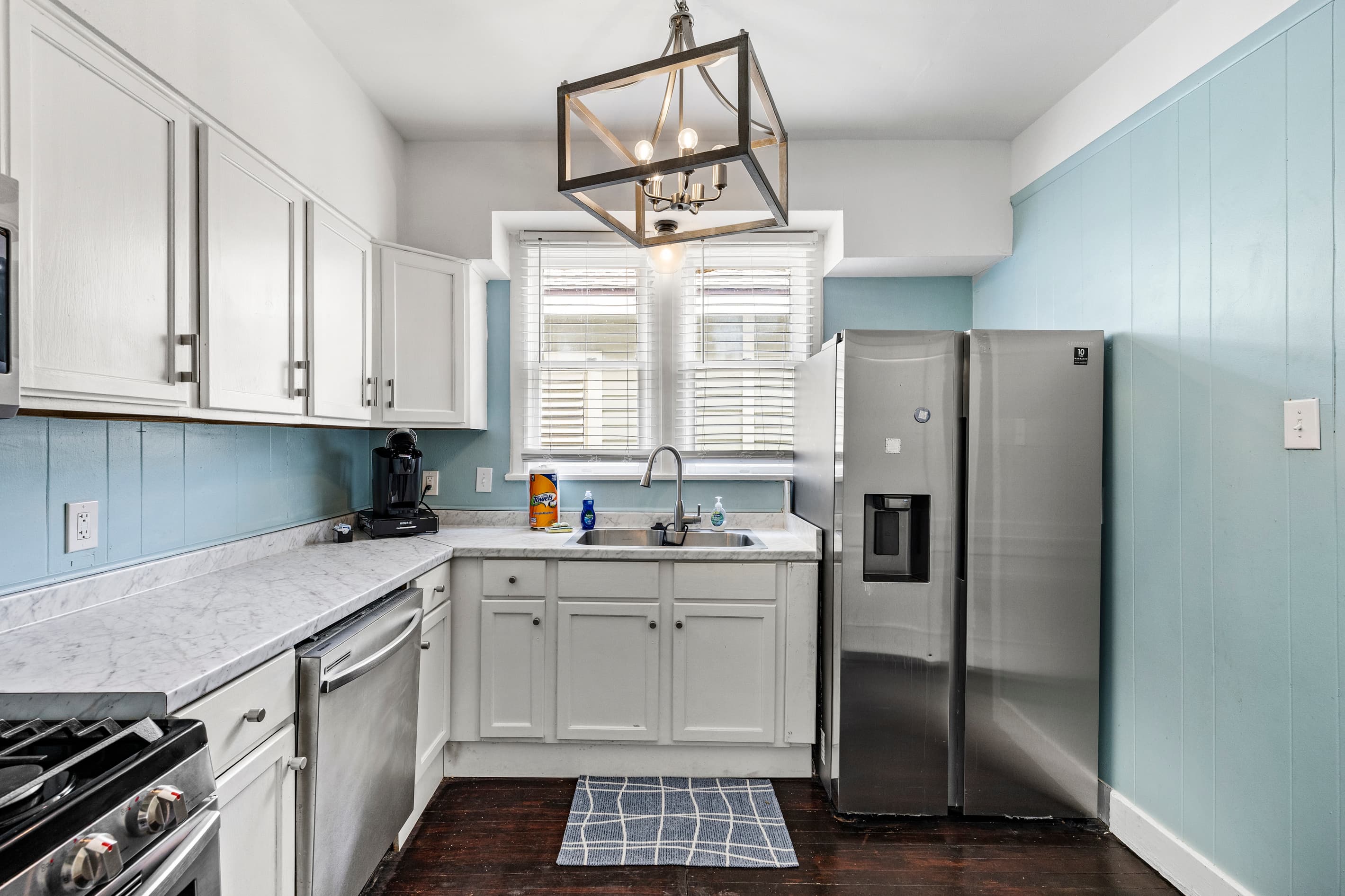 Gas stove, full appliances, and plenty of prep space — the kitchen at Port Side at M is stocked for real cooking.