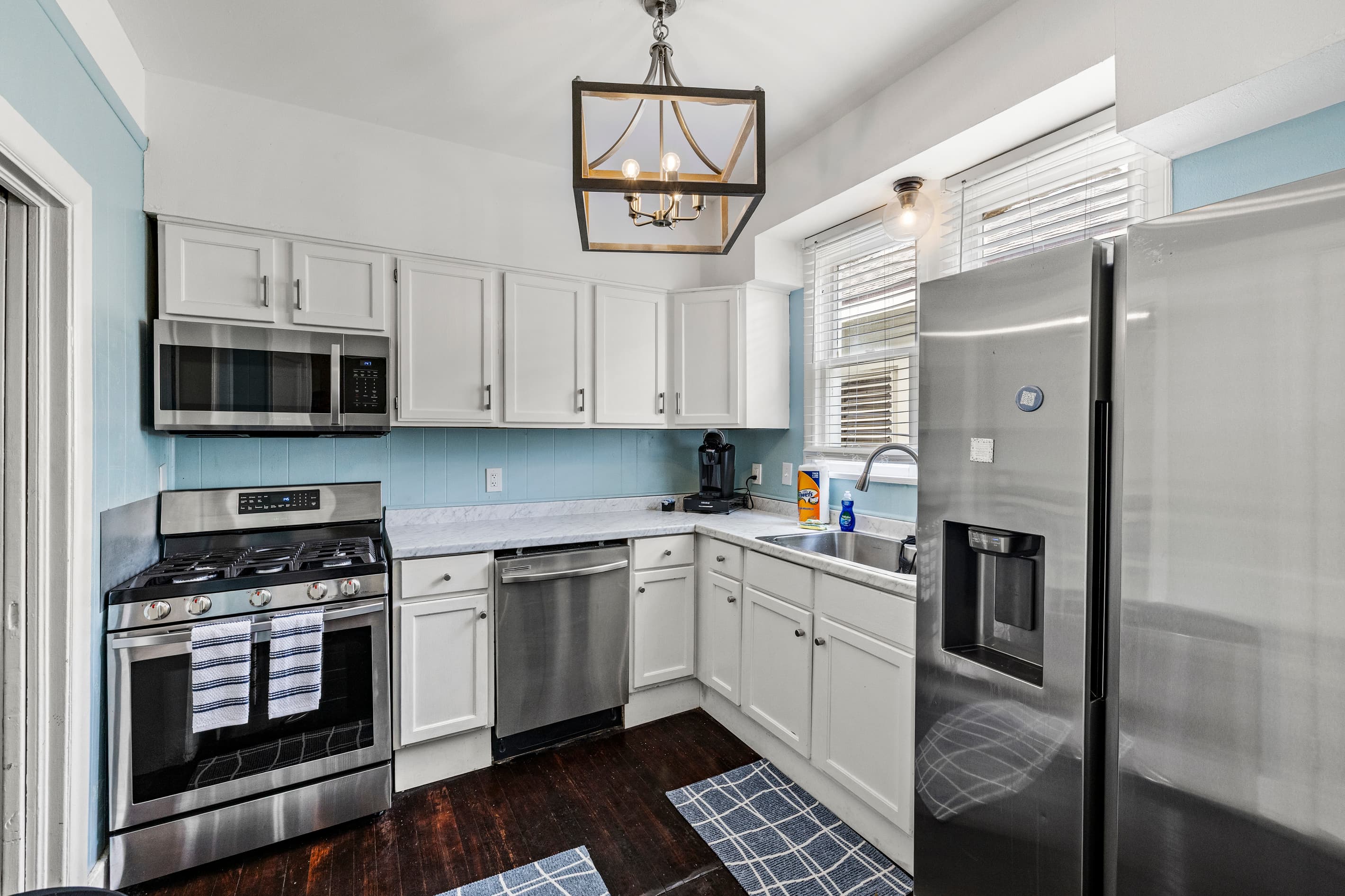 A stainless steel refrigerator and clean, bright cabinetry — cook in or store your catch after a day on the water.