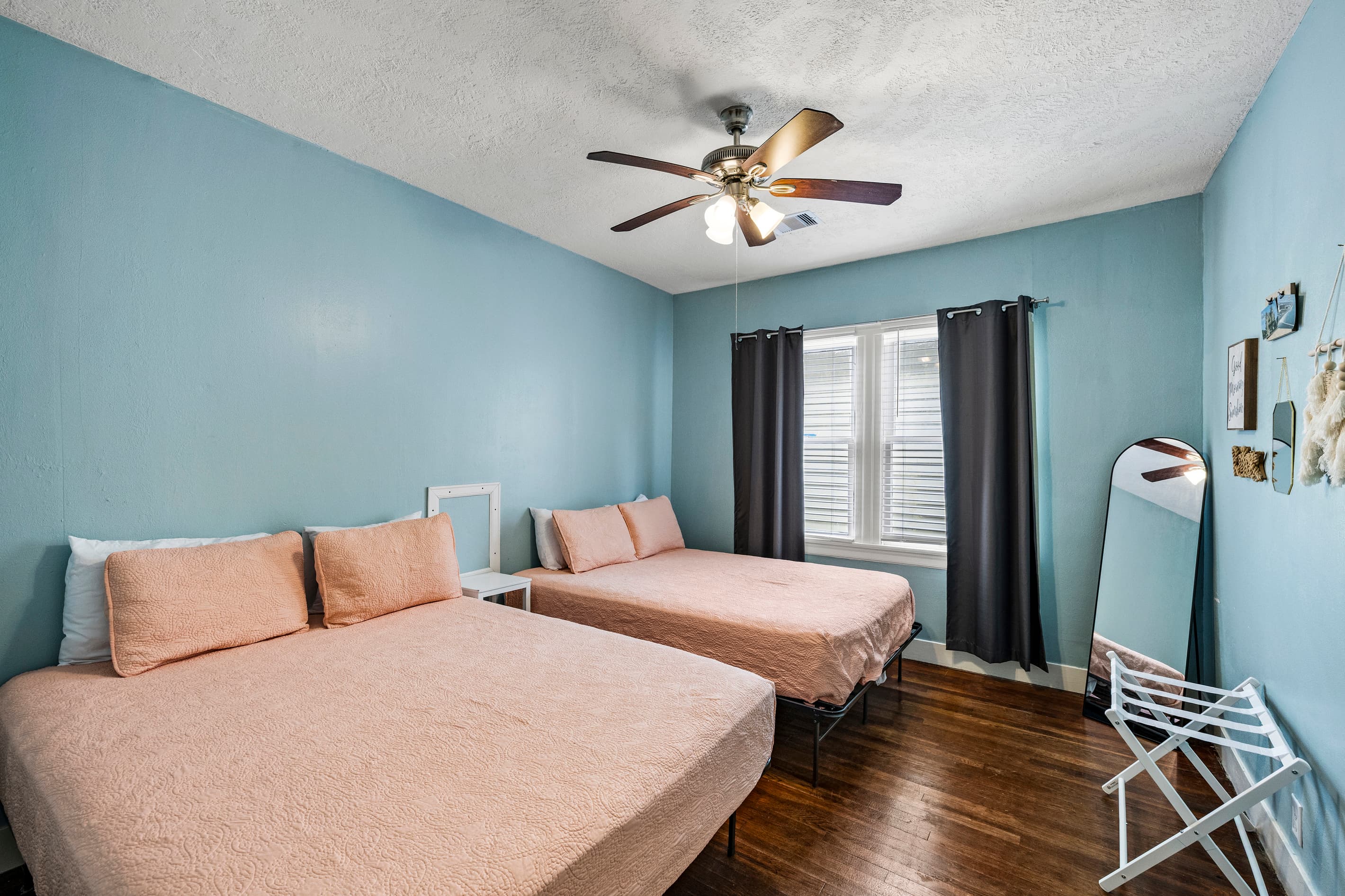 The second bedroom offers two queen beds — comfortable space for the whole group, with quality linens provided.