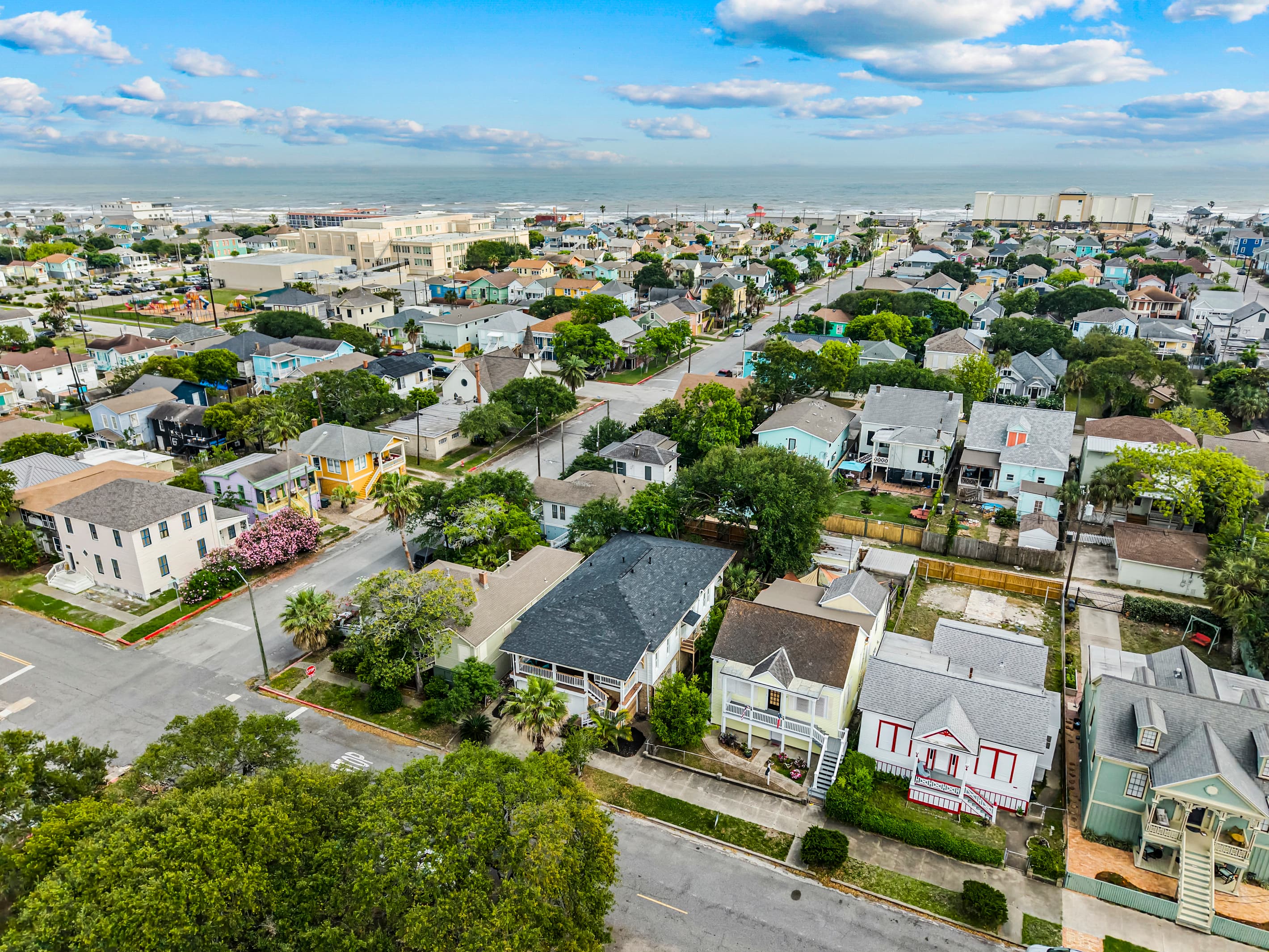 Galveston's historic Lost Bayou District from above — tree-lined streets and the Gulf just blocks from Port Side at M.