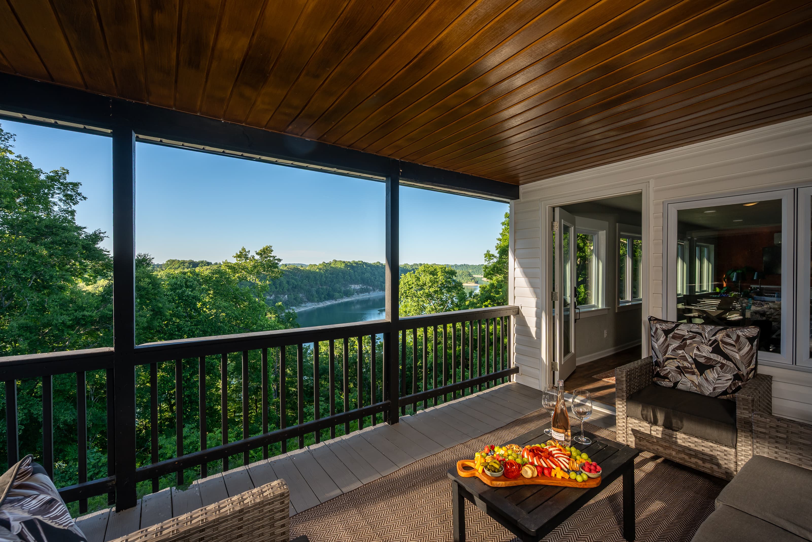 Covered upper deck lounge with beautiful lake views and outdoor dining atmosphere.
