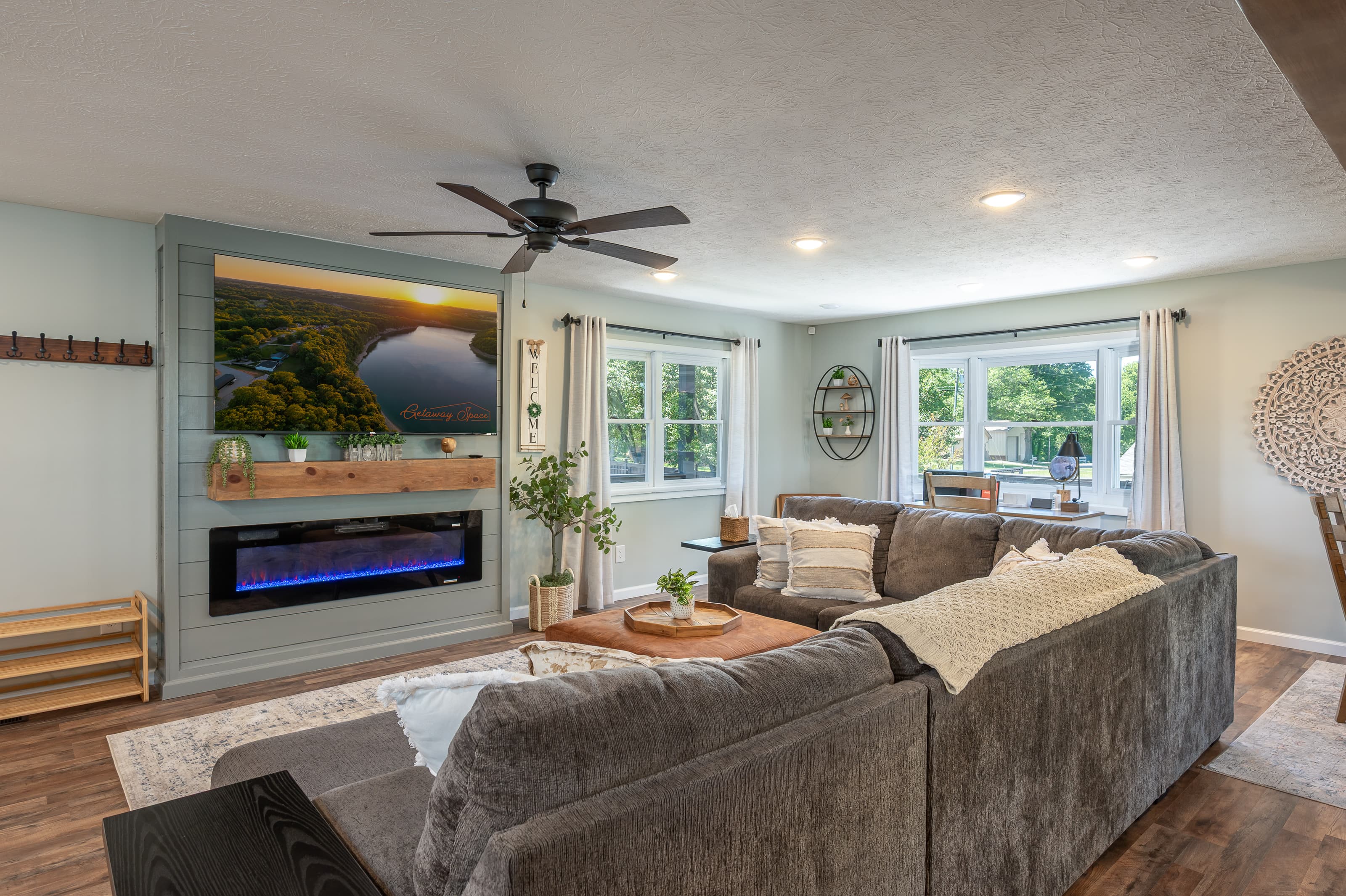 Comfortable oversized sectional living area with fireplace and large smart TV.