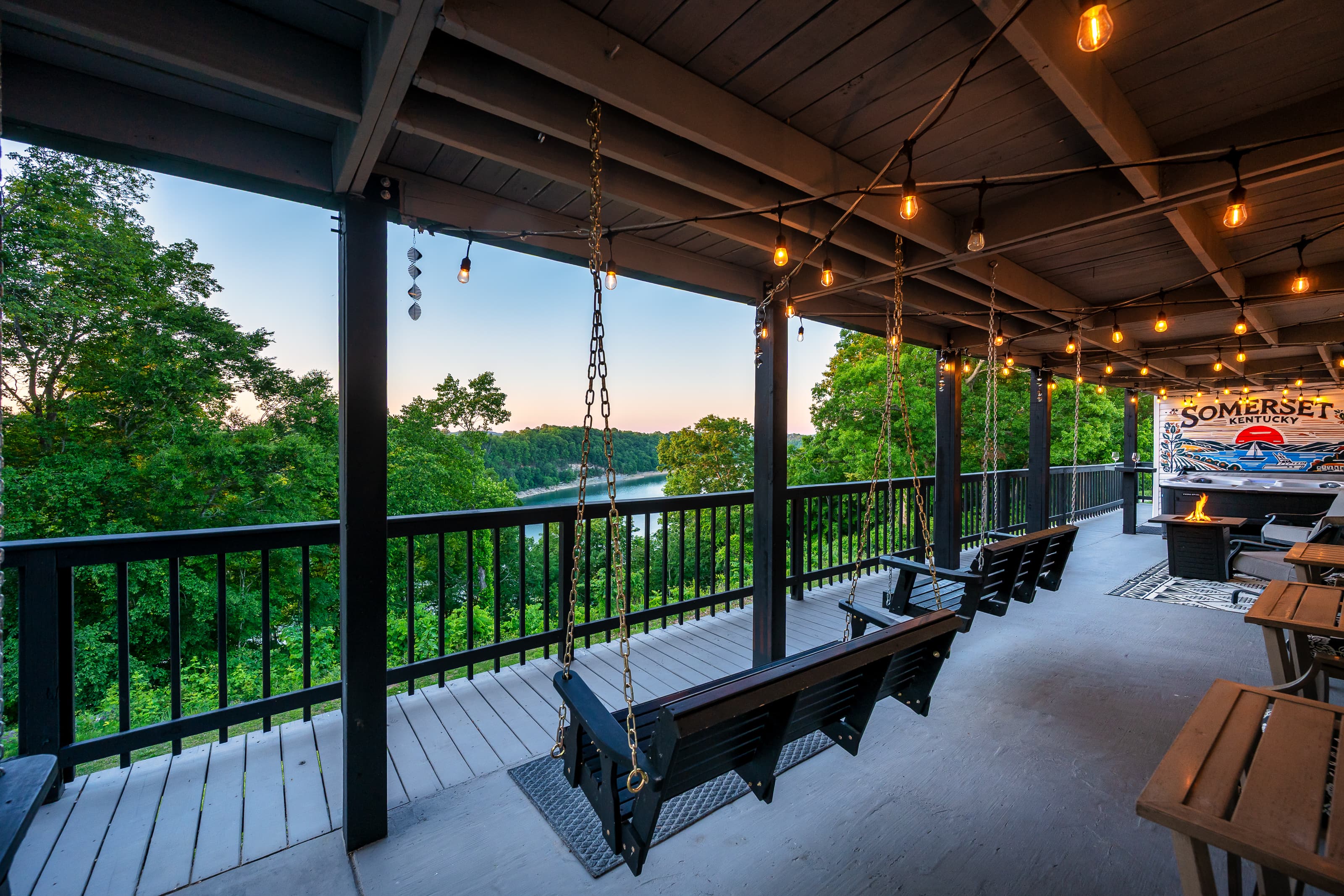 Relax under the covered deck beside the fire feature, hot tub, and swinging chairs.