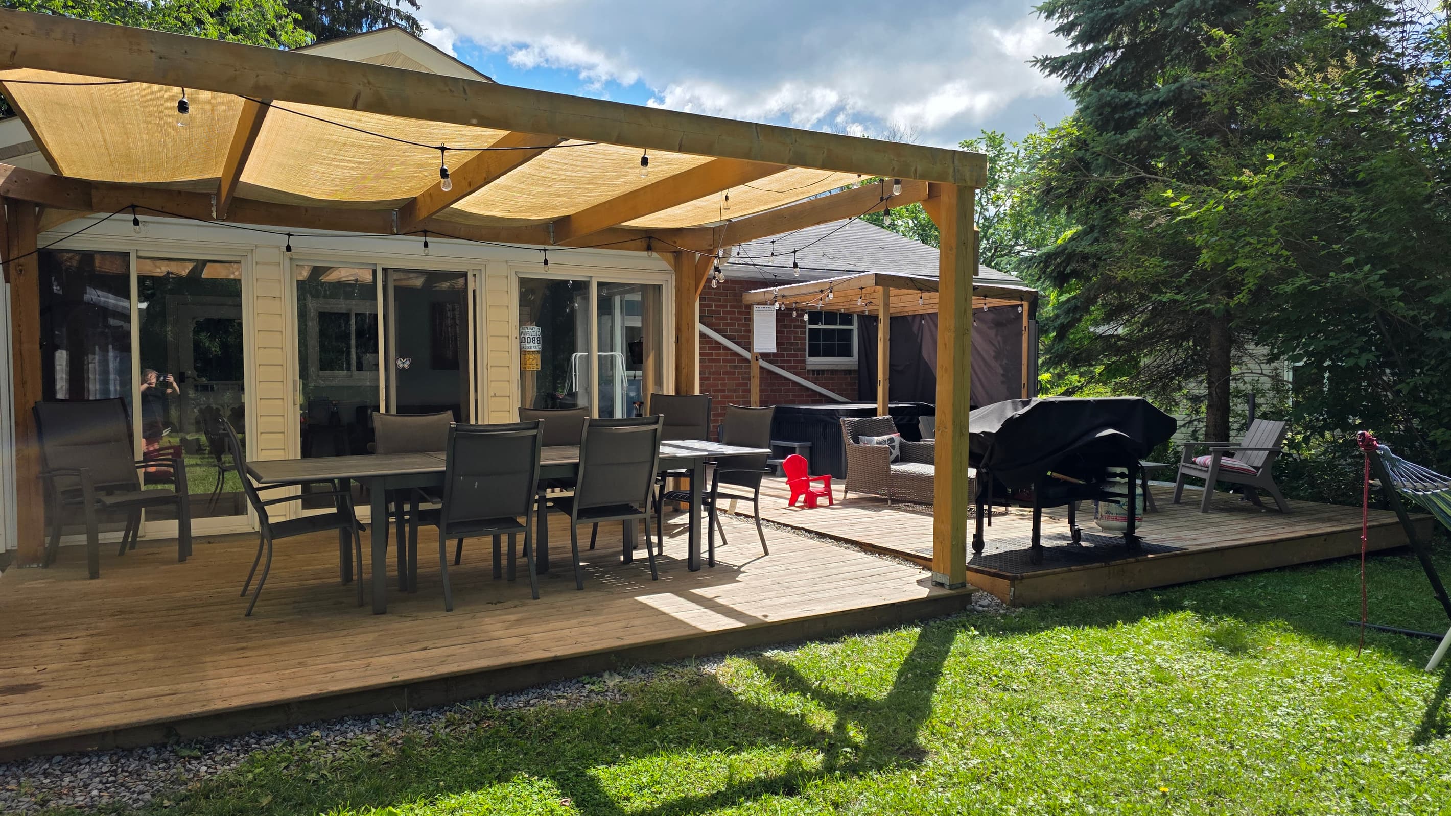 Spacious deck for every mood—grill, dine, lounge, or soak in the rain-proof hot tub.