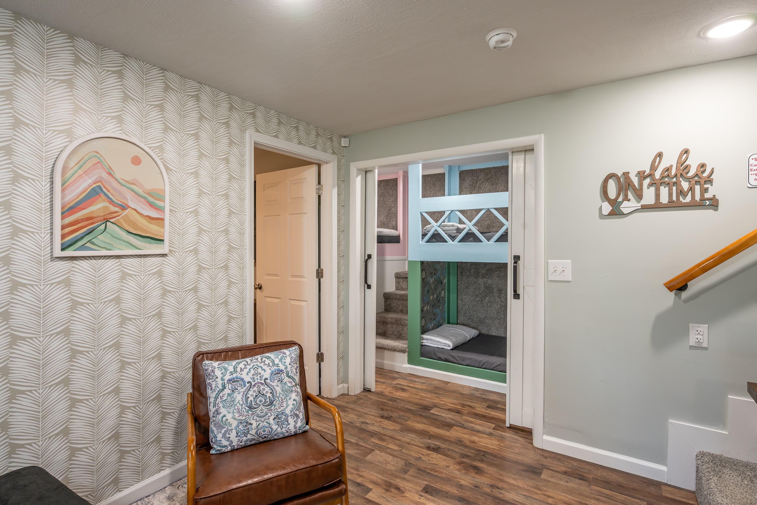 Sitting area in lower level outside of queen sized bedroom and bunk beds. 